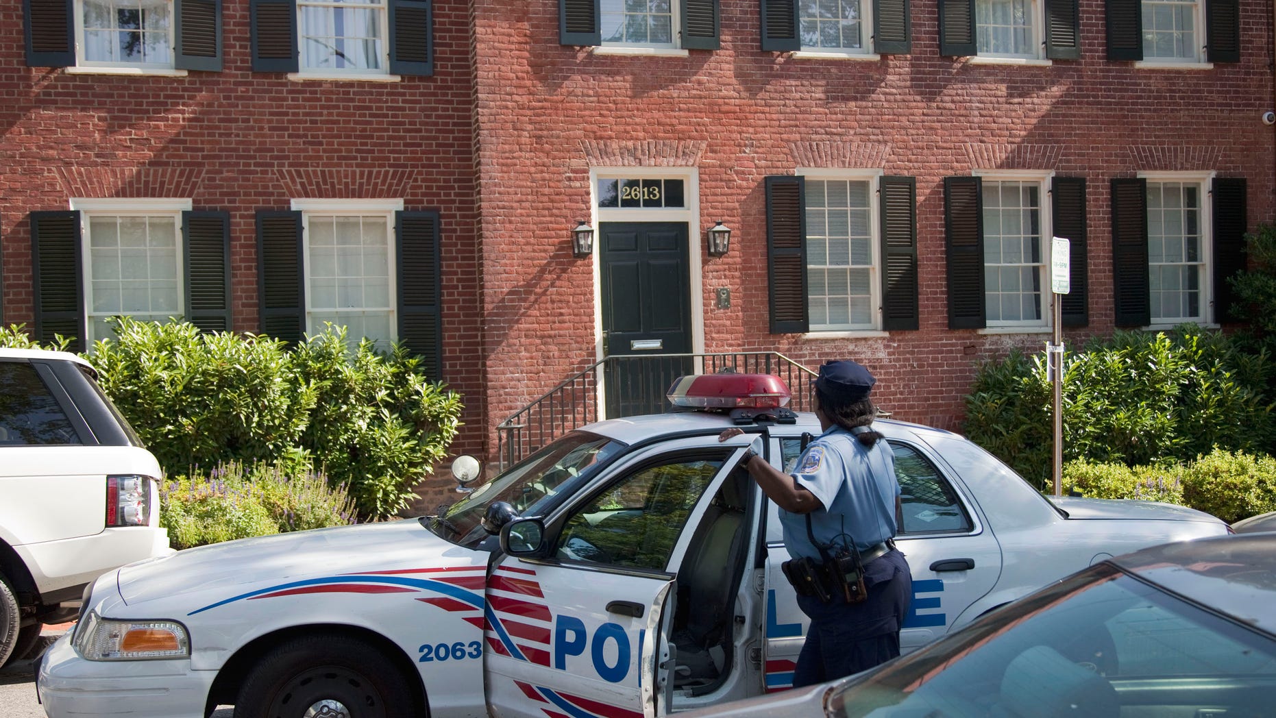 A Washington police officer arrives at the home of former IMF Managing Director Dominique Strauss-Kahn, Thursday, June 2, 2011, in Washington. An alarm company concerned about an open door called police to the home, but an official says there are no signs of a burglary.