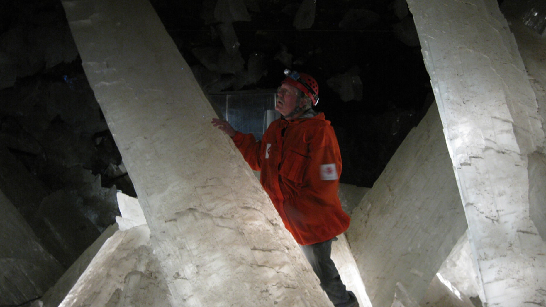 Mike Spilde, a professor at the University of New Mexico, gazes at giant selenite crystals in a chamber in the Naica Mine.