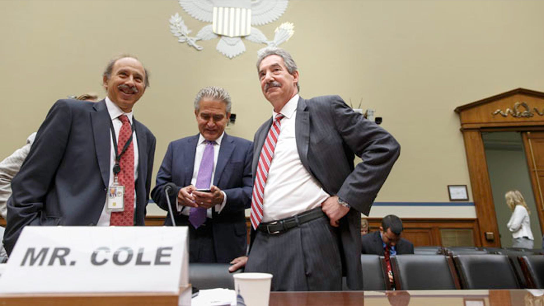 Deputy Attorney General James Cole, right, arrives on Capitol Hill in Washington, Thursday, July 17, 2014, to testify before the House Economic Growth, Job Creation, and Regulatory Affairs subcommittee hearing on how the Justice Department is investigating allegations that the Internal Revenue Service (IRS) targeted conservative political groups for extra scrutiny.