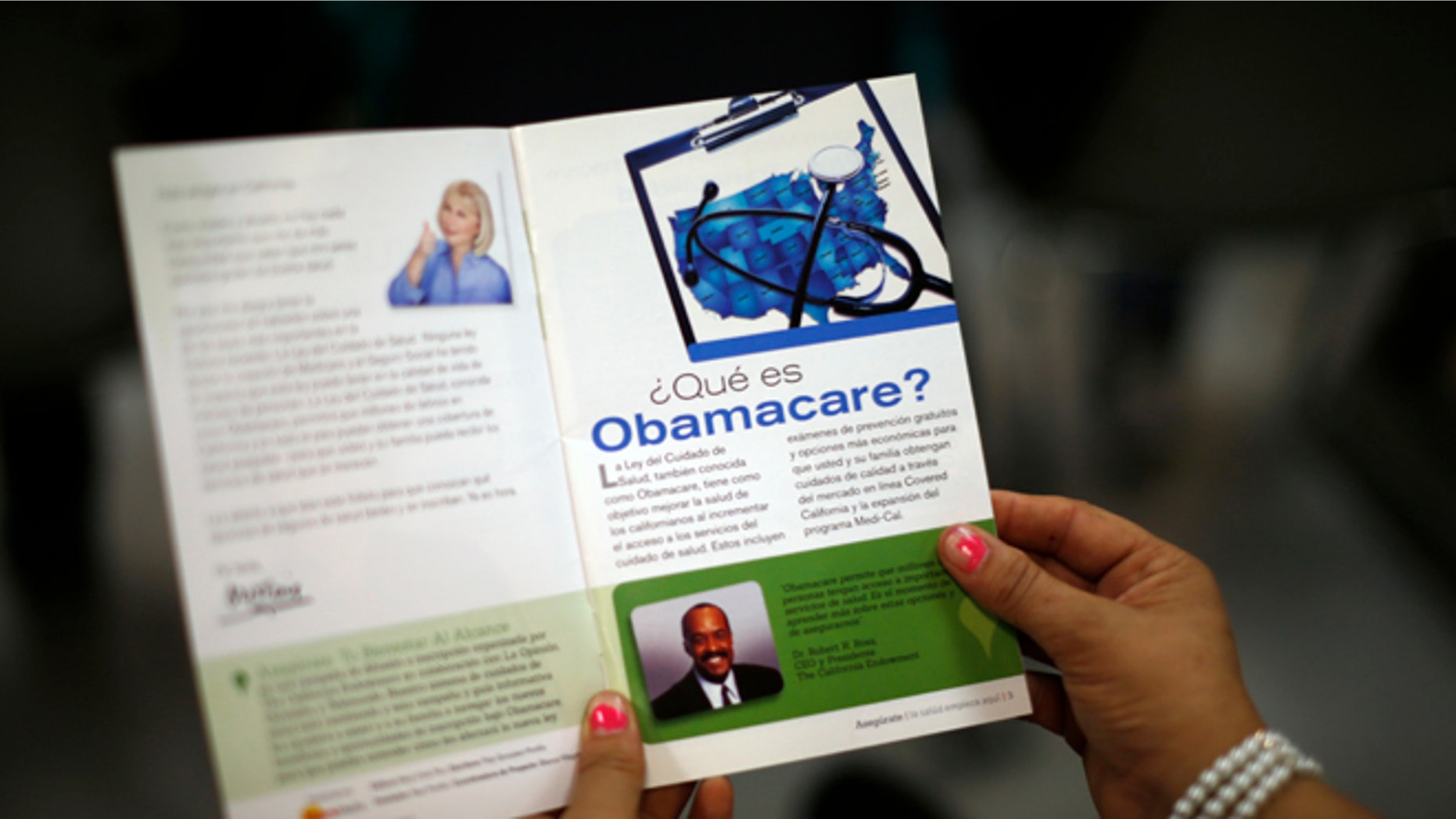 FILE: March 27, 2014: A woman reads a pamphlet in Spanish at a health insurance enrollment event in Cudahy, Calif.
