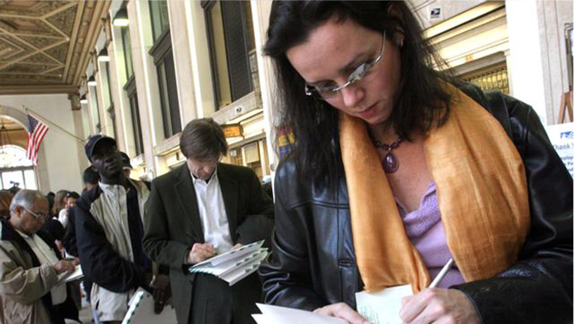 FILE: April 15, 2005: Tax filers fill out a form for certified mail at the General Post Office in New York before sending in her tax returns.