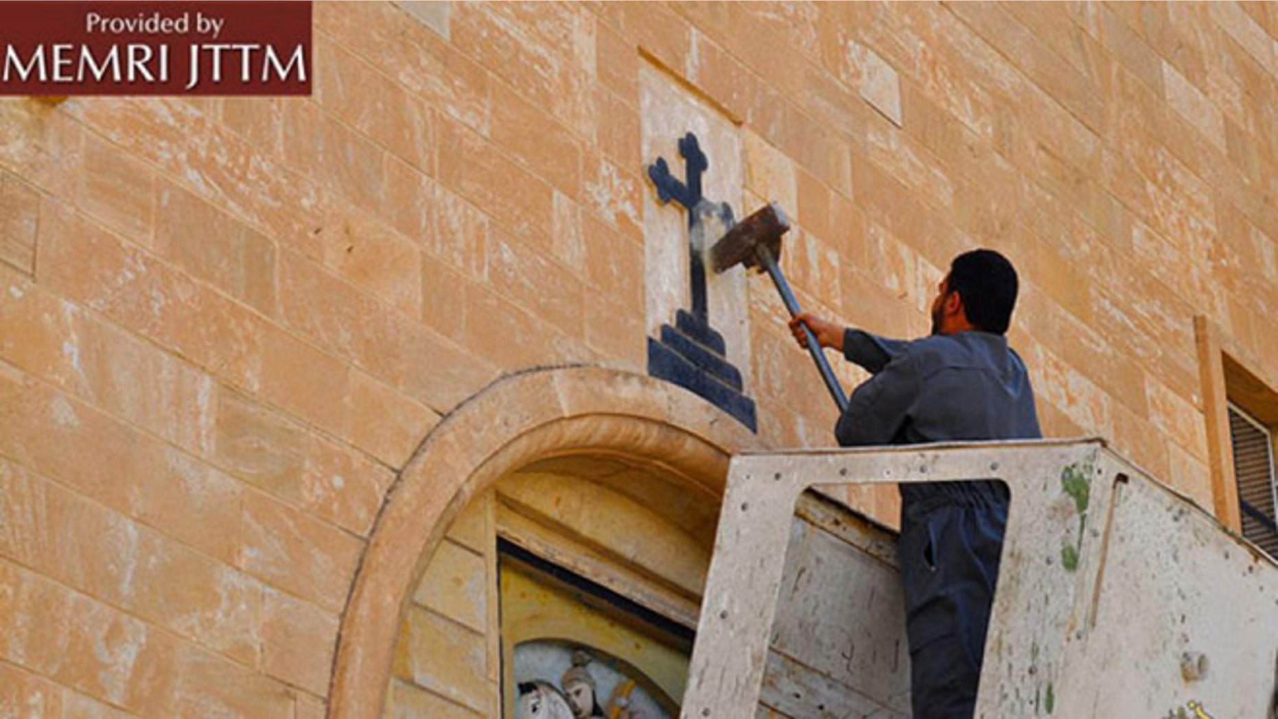 ISIS men destroy various Christian symbols in Nineveh, Iraq.