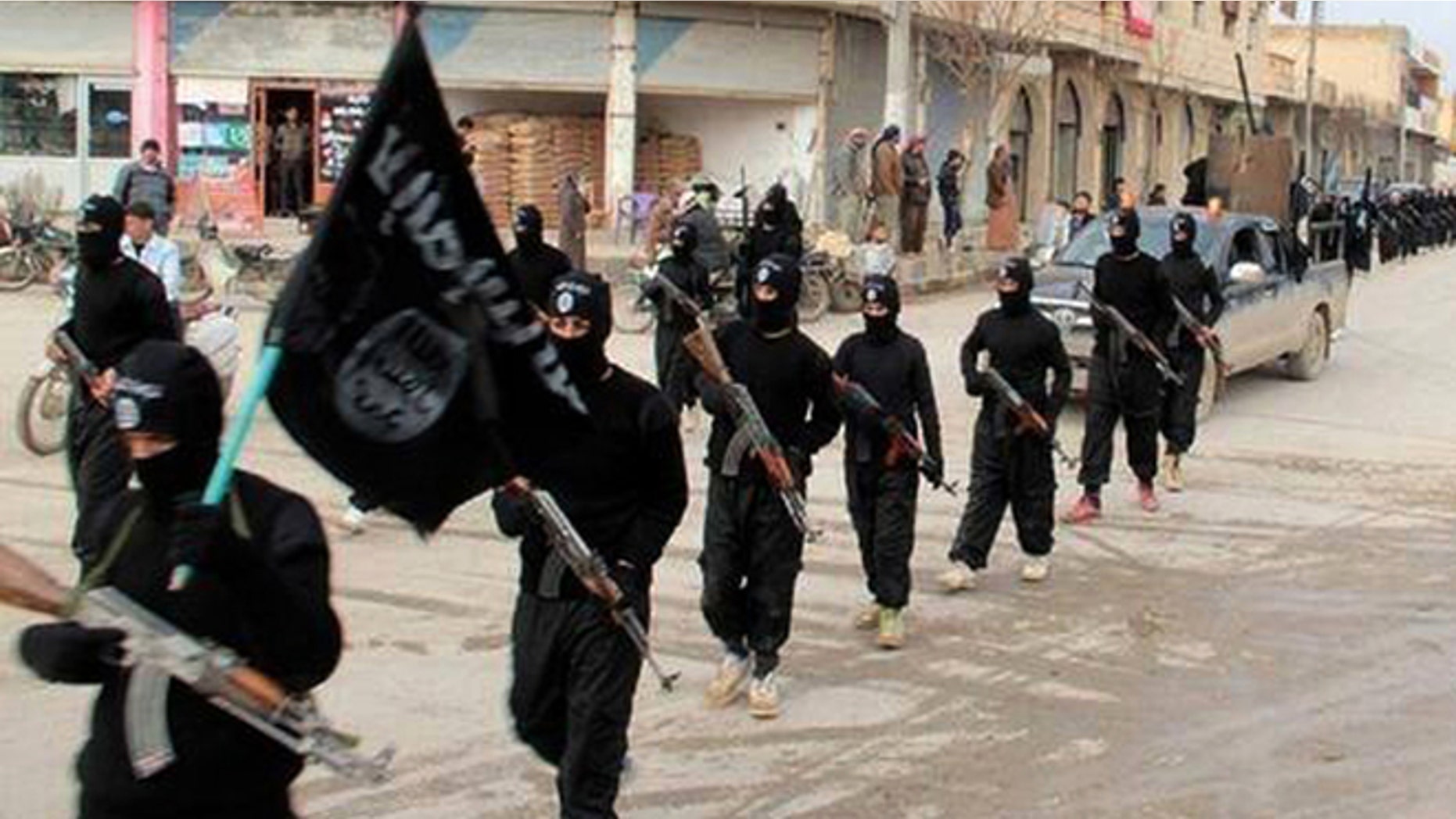 Jan. 14, 2014: Fighters from ISIS marching in Raqqa, Syria.