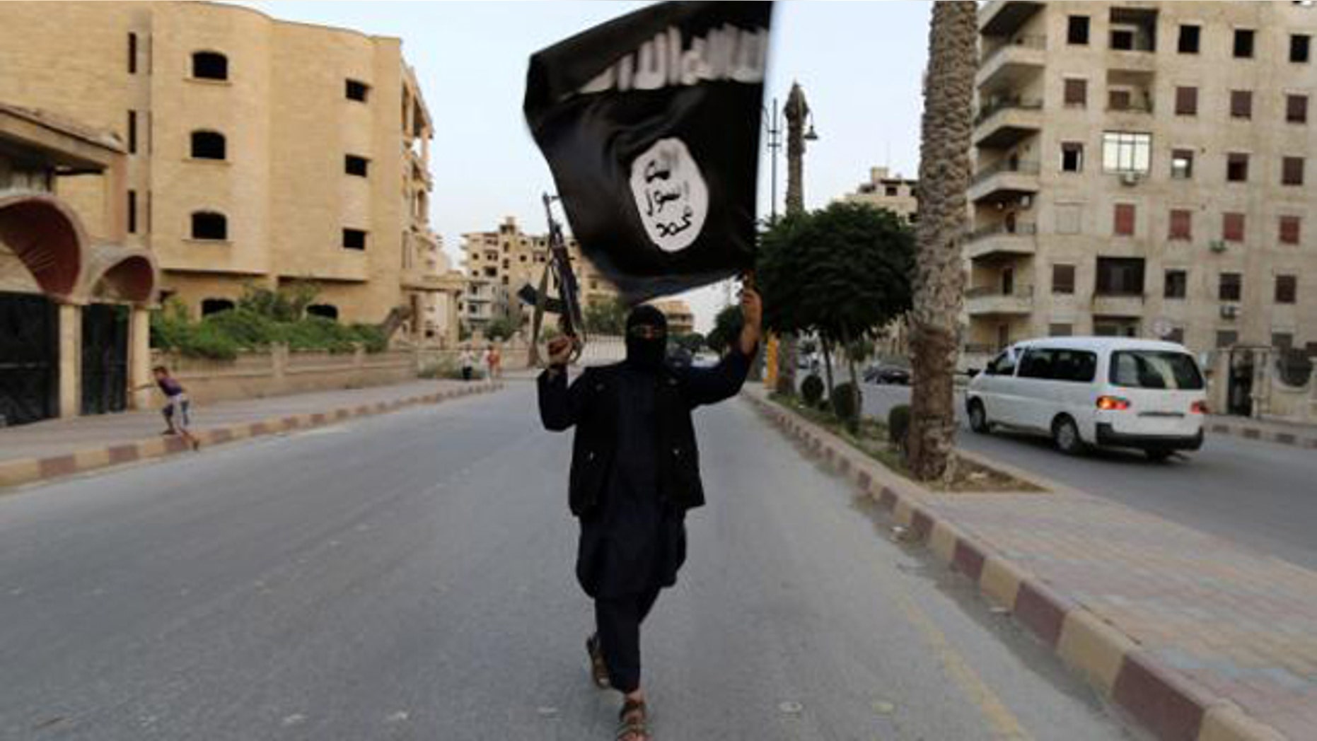 June 29, 2014: A member loyal to the Islamic State in Iraq and the Levant (ISIS) waves an ISIS flag in Raqqa, Iraq. (Reuters)