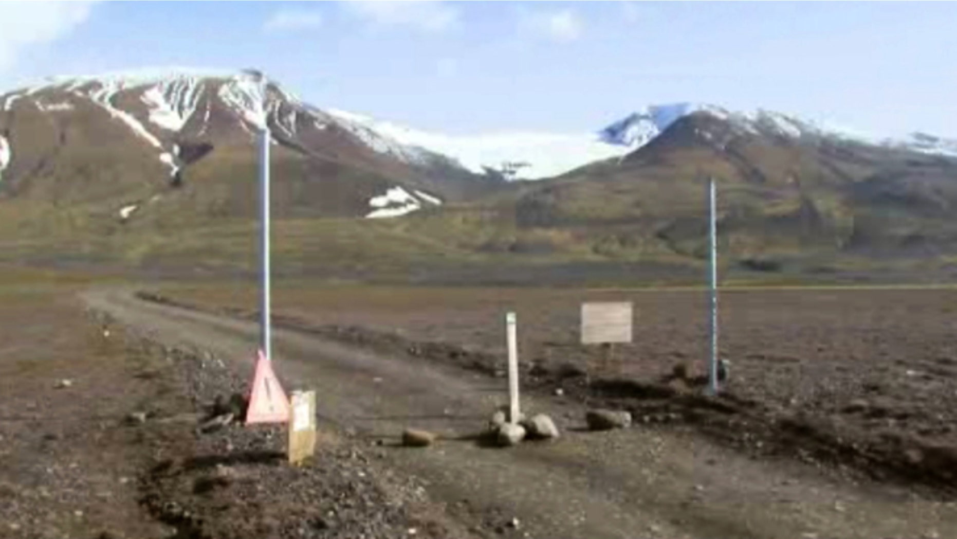 In an image from an Aug. 19, 2014 video, a sign is posted on the road next to Bardarbunga, a subglacial stratovolcano located under Iceland's largest glacier. (AP/Courtesy Channel 2 Iceland)