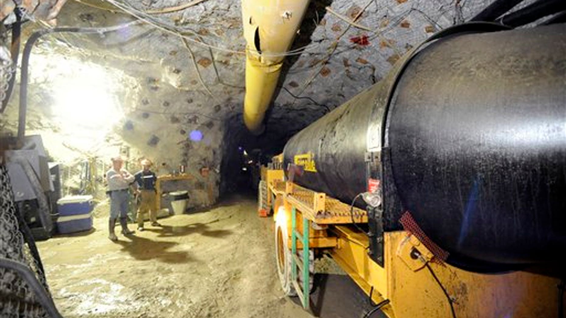 In this Nov. 24, 2010 photo, two mine workers stand inside the Lucky Friday mine in Mullan, Idaho. The roof of the tunnel collapsed on Friday, April 15, 2011, trapping Larry Marek. Officials have not had contact with him and don't know his condition.(AP/The Spokesman-Review)