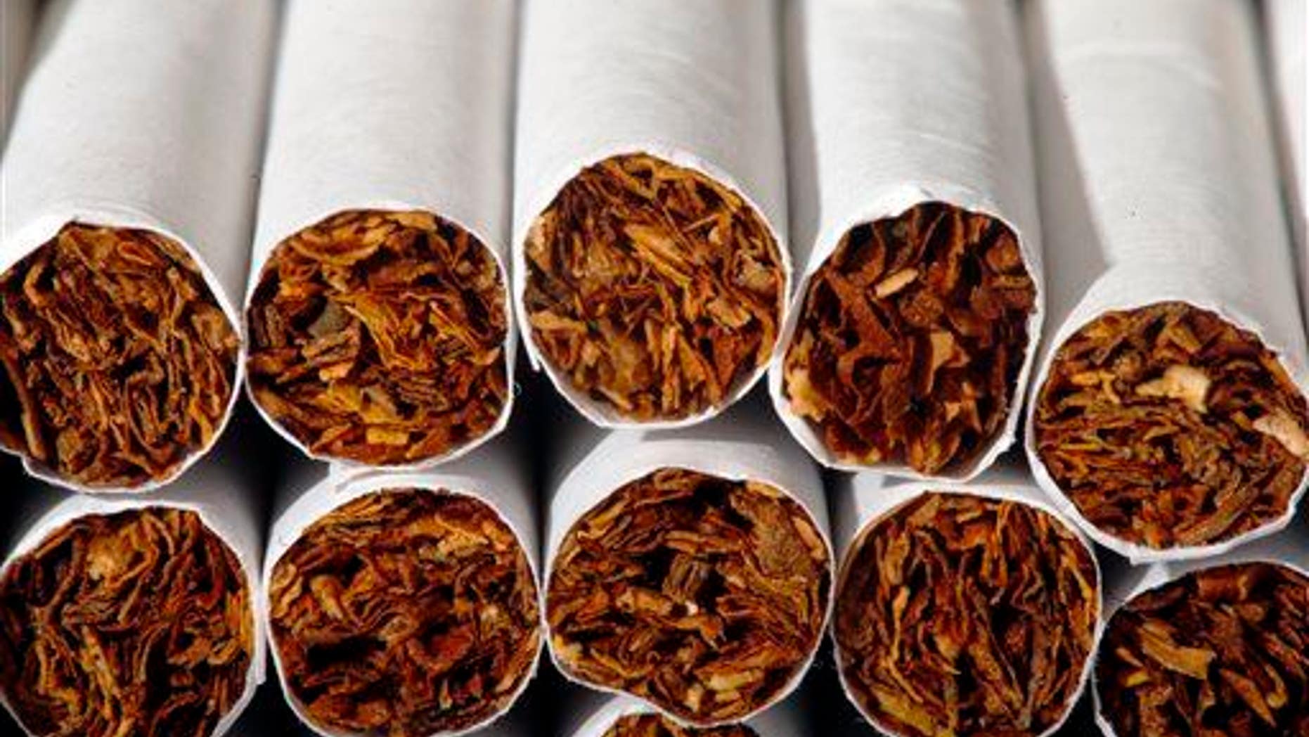 This Tuesday, July 15, 2014 photo shows the tobacco in cigarettes in Philadelphia. A study ties a host of new diseases to smoking, and says an additional 60,000 to 120,000 deaths each year in the United States are probably due to tobacco use. The study by the American Cancer Society and several universities is published in the Thursday, Feb 12, 2015 edition of the New England Journal of Medicine. It looks beyond lung cancer, heart disease and other conditions already tied to smoking and adds breast cancer, prostate cancer and even routine infections to the list.
