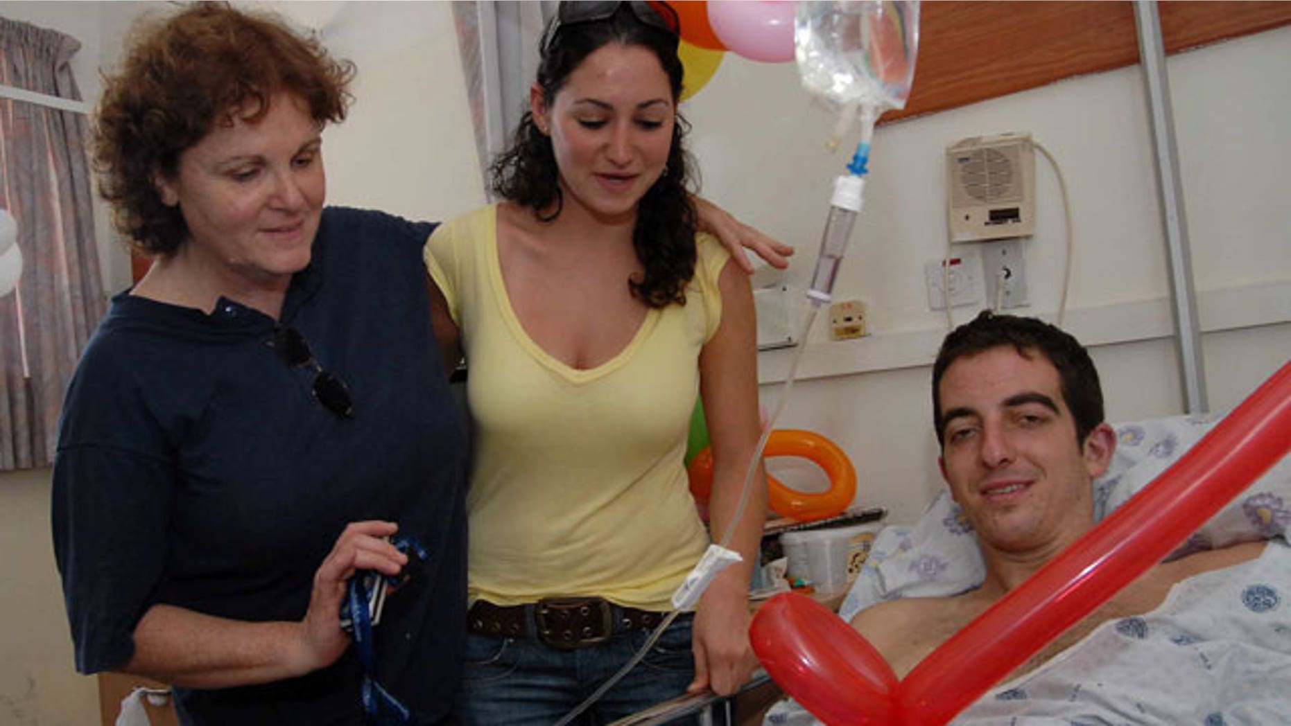 In this photo taken on Aug. 3, 2006, Israeli, U.S-born, Ilan Grapel, right, pauses for a photographer as he is hospitalized after he was injured during the Israel Lebanon war at the Rambam hospital in the northern Israeli city of Haifa.
