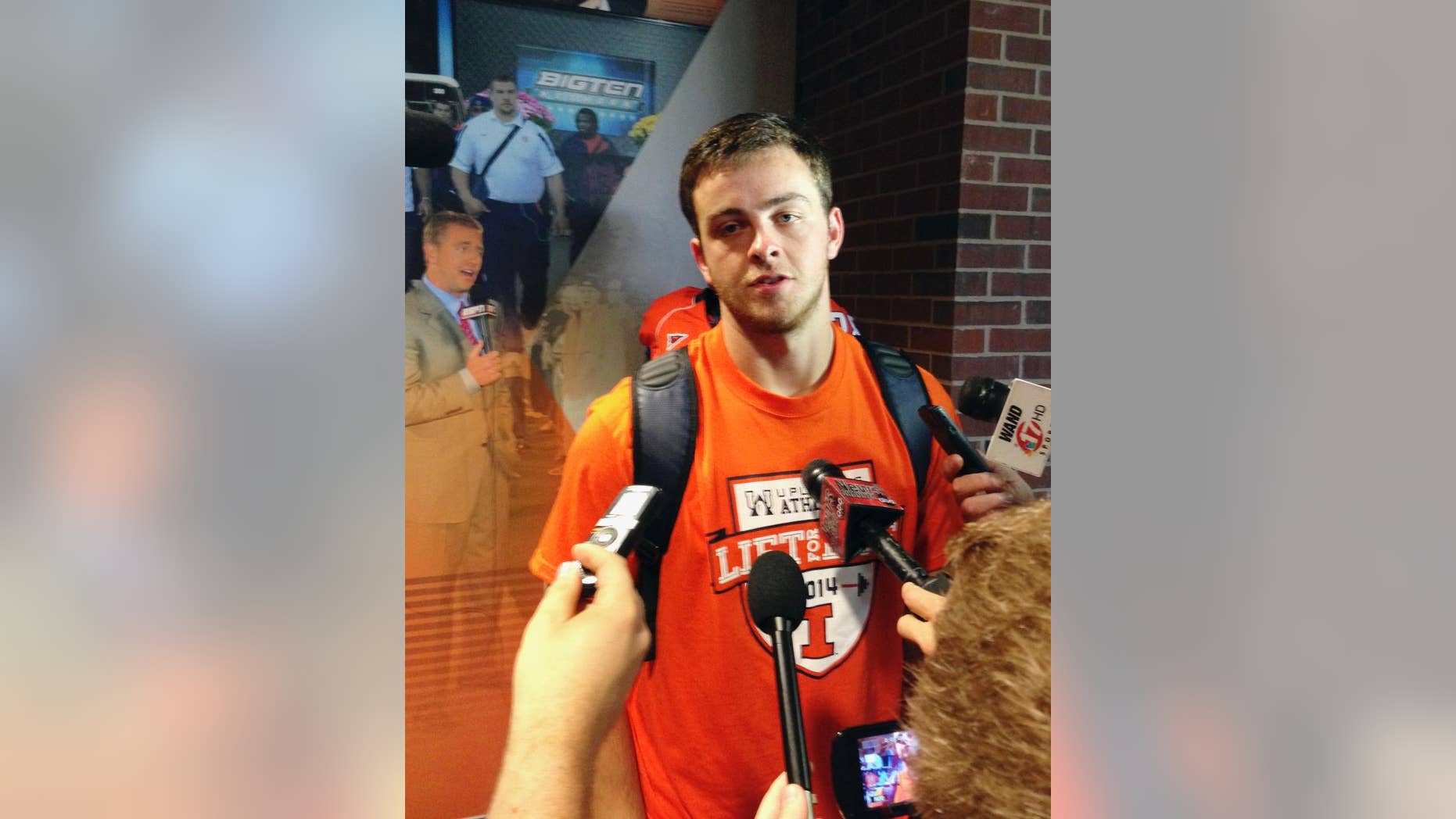 Illinois quarterback Wes Lunt talks with reporters at Memorial Stadium in Champaign, Ill., on Wednesday, Aug. 20, 2014, after learning he will be the starting Illini quarterback. Lunt transferred from Oklahoma State after starting as a freshman but sat out last season under NCAA transfer rules. Illinois starts its season Aug. 30 against Youngstown State. (AP Photo/David Mercer)