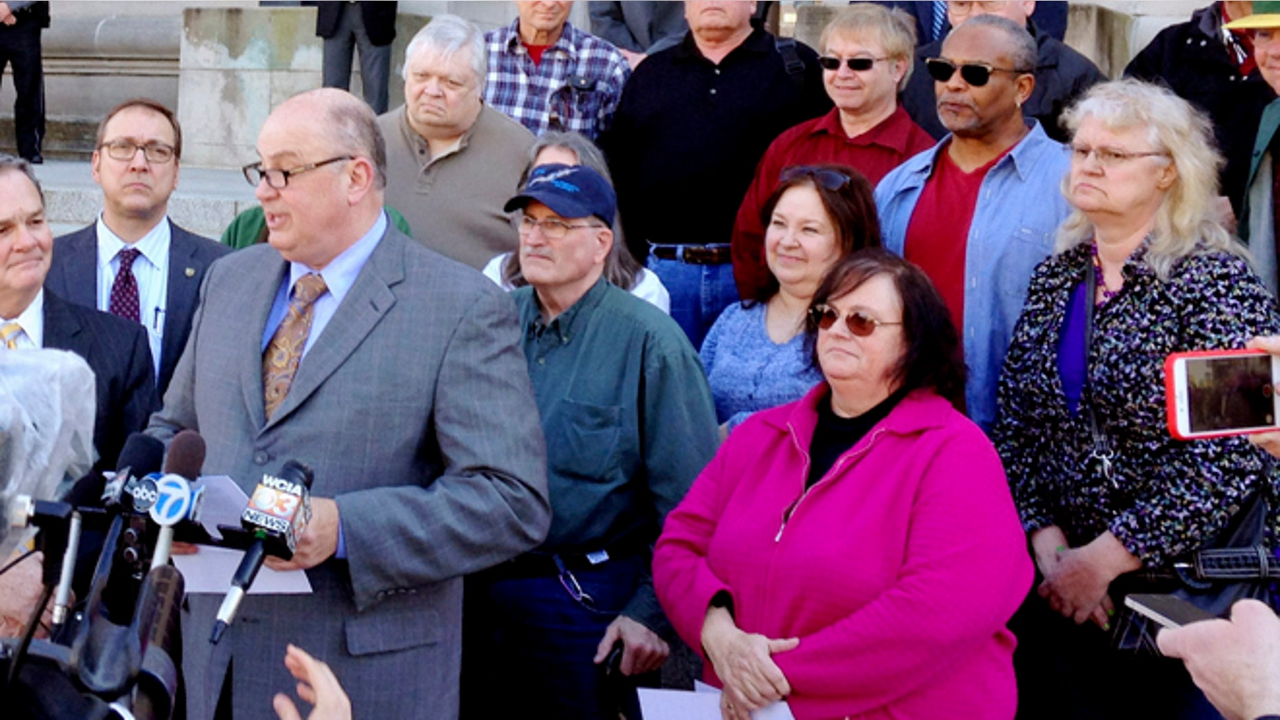 March 11, 2015: Illinois AFL-CIO President Michael Carrigan is joined by state workers and retirees outside the Illinois Supreme Court in Springfield, Ill., as he addresses the media following oral arguments in a lawsuit over a state pension overhaul.
