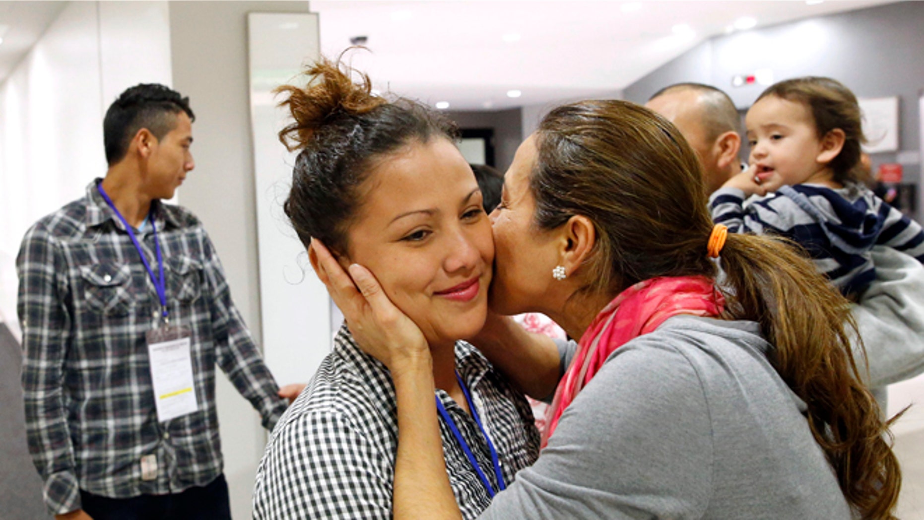 In this Nov. 12, 2015, photo, Wendy Mejia, 16, hugs her aunt after her arrival from El Salvador at Baltimore-Washington International Airport in Linthicum, Md. After 15 years apart, Wendy and her brother Brian reunited with their parents, becoming among the first teenagers to be granted refugee status and permission to travel legally to the United States through the State Department's Central American Minor program. (AP Photo/Patrick Semansky)