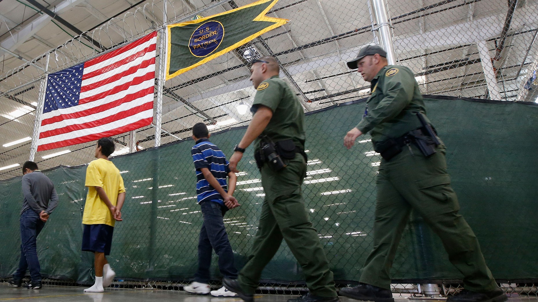 Young detainees being escorted to an area to make phone calls on June 18, 2014 in Nogales, Ariz.