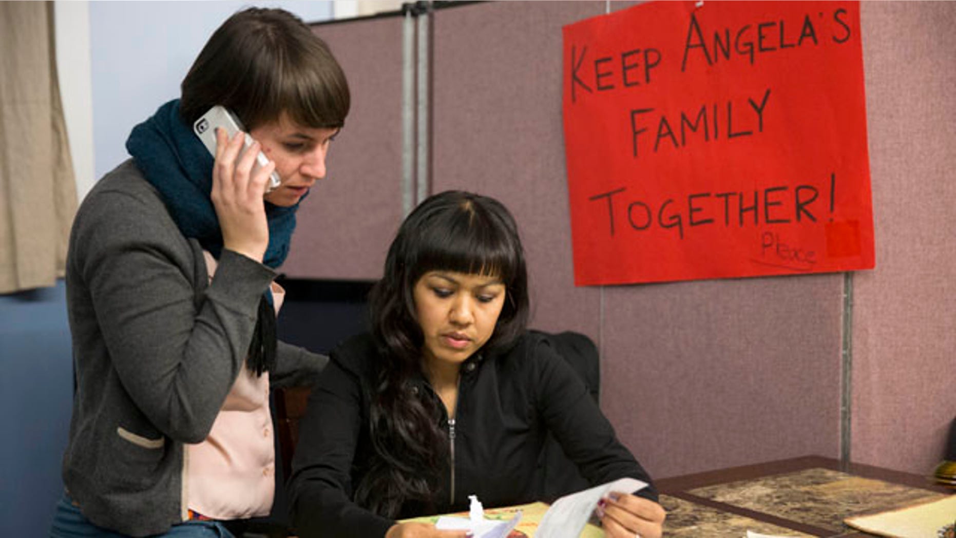 Dec. 8, 2014: Angela Navarro, right, who has been living in the U.S. with her American-born children despite a deportation order issued 10 years ago looks over a letter with New Sanctuary Movement community organizer Nicole Kligerman at the West Kensington Ministry church in Philadelphia. (AP Photo/Matt Rourke)
