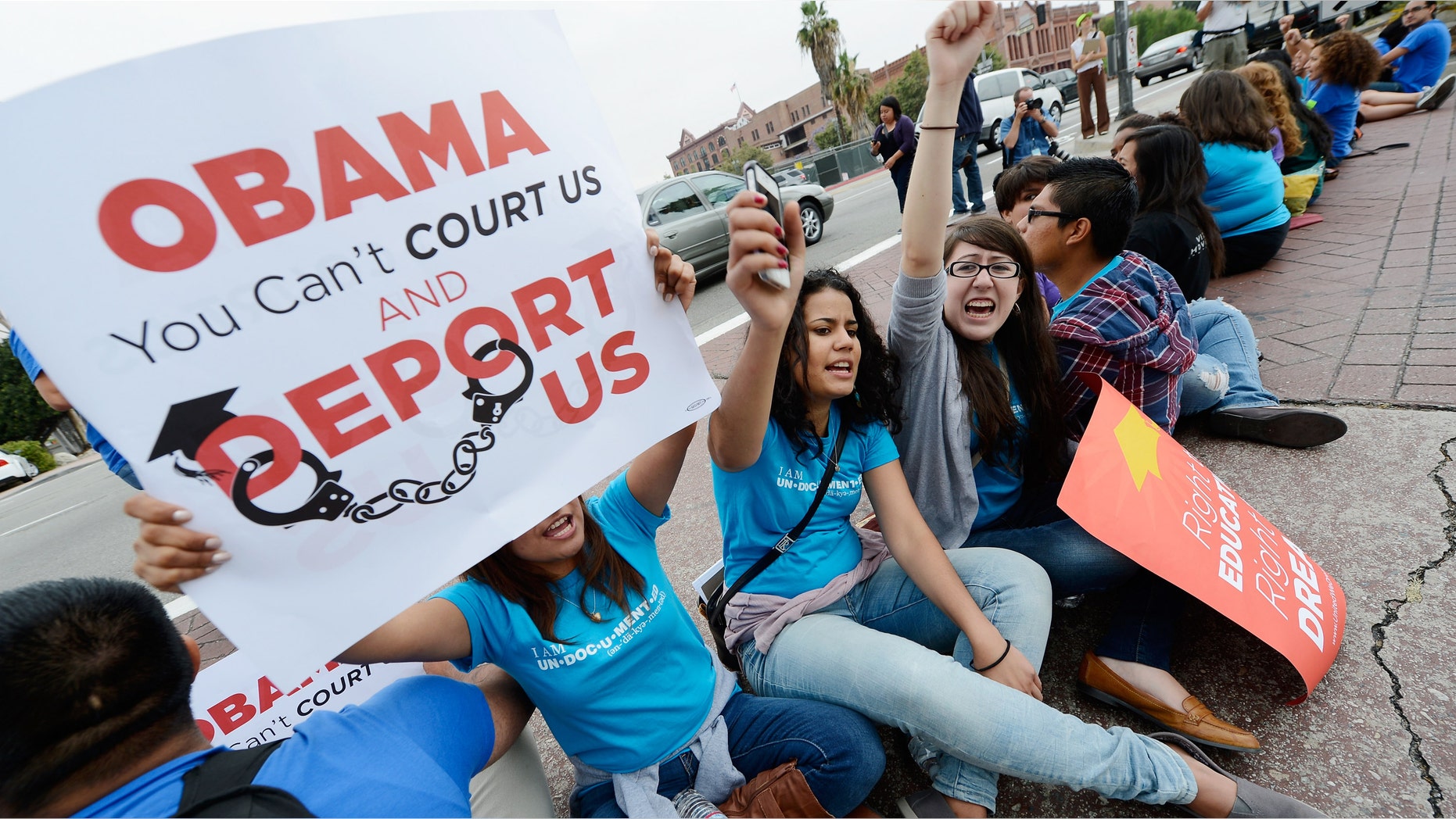 LOS ANGELES, CA - JUNE 15: Students (L-R) Sarait Escorza, 23, Isabelle Vargas, 20, and Maricella Aguilar, 21, block the on ramp of US101 freeway during a demonstration by immigrant students for an end to deportations and urge relief by governmental agencies for those in deportation proceedings on June 15, 2012 in Los Angeles, California. In a policy change, the Obama administration said it will stop deporting young illegal immigrants who entered the United States as children if they meet certain requirements. (Photo by Kevork Djansezian/Getty Images)