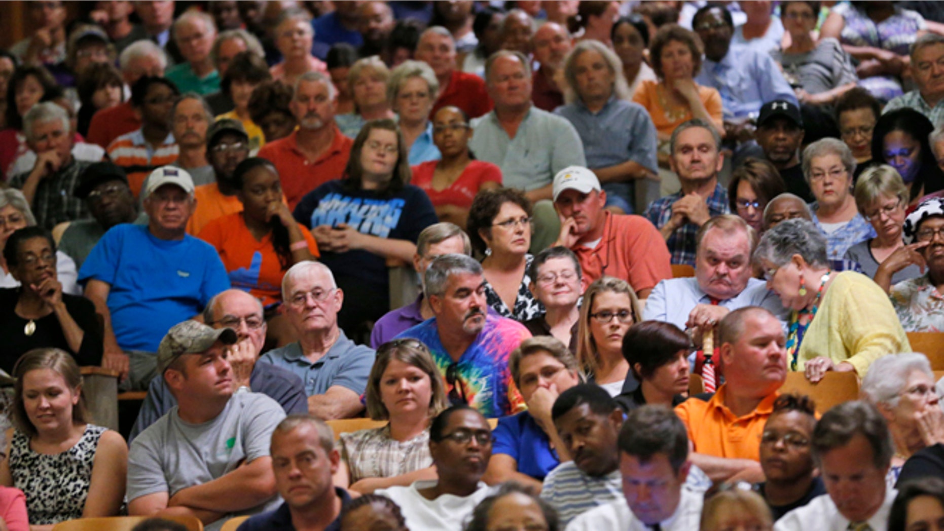 June 19: Town residents listen during a presentation by federal officials involved in the placement of immigrant children at St Paul's College in Lawrenceville, Va.