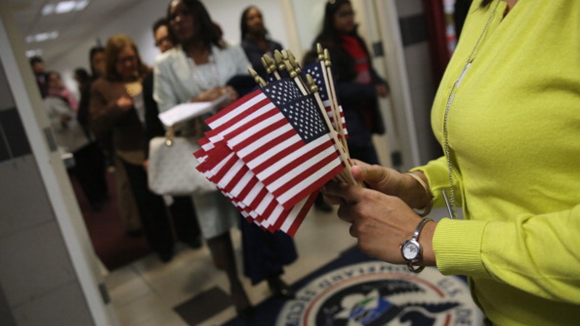 NEW YORK, NY - JANUARY 17: Immigrants arrive for a naturalization ceremony held at the U.S. Citizenship and Immigration Services (USCIS) office on January 17, 2014 in New York City. One hundred and fifty-three people from 41 countries became American citizens at the event. (Photo by John Moore/Getty Images)