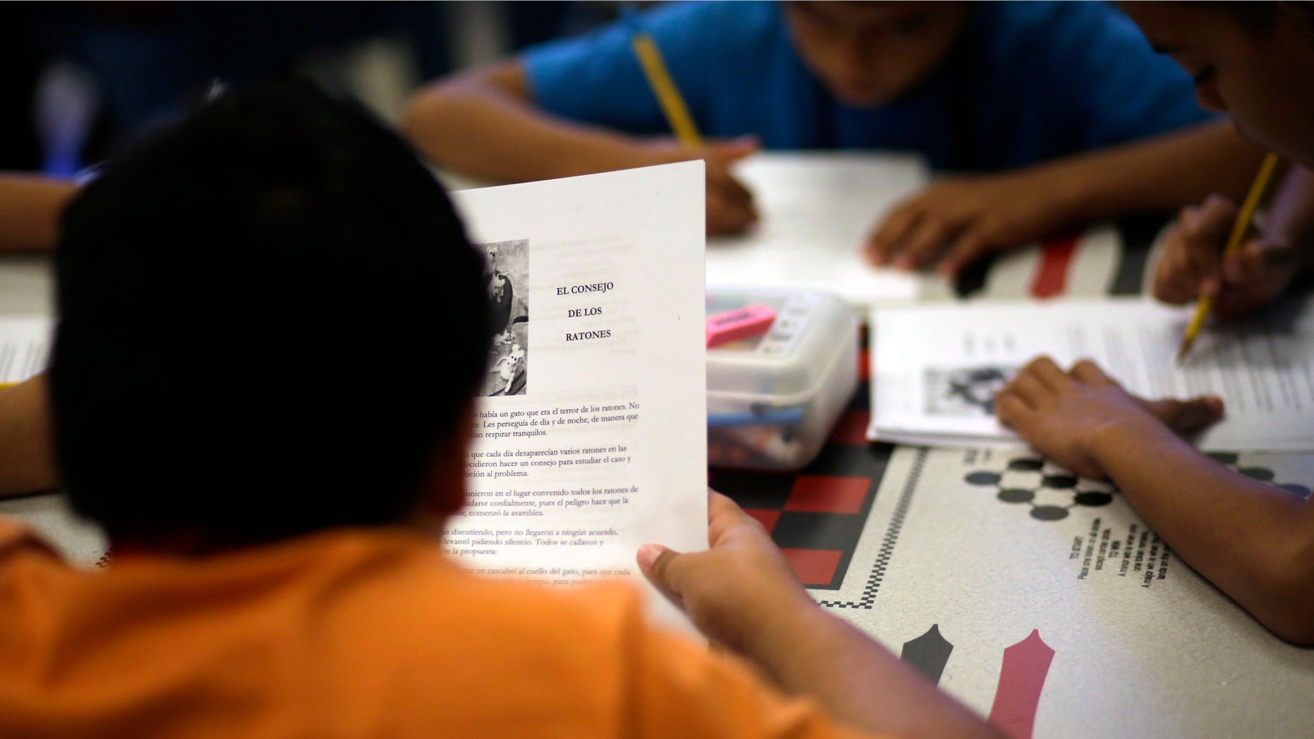 In this Wednesday, Sept. 10, 2014 photo, a short story in Spanish is used in a class at the Karnes County Residential Center, a temporary home for immigrant women and children detained at the border, in Karnes City, Texas. (AP Photo/Eric Gay)