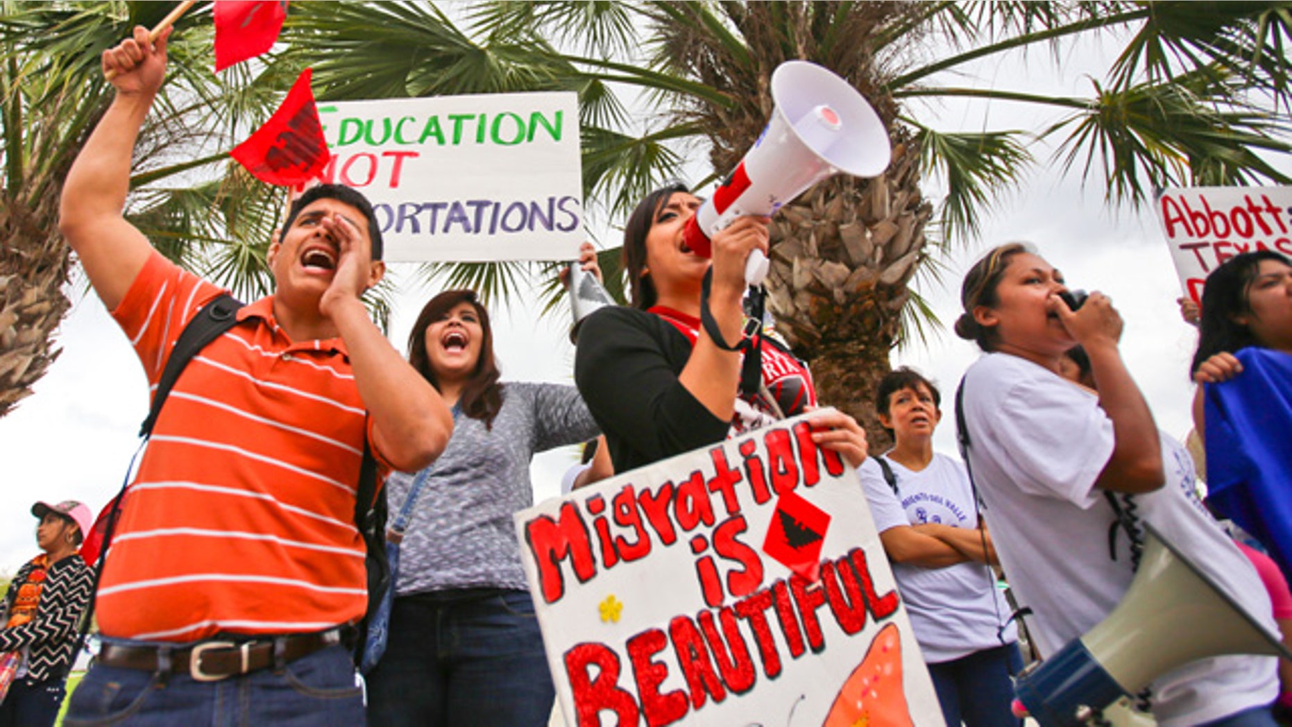 March 19, 2015: Over a hundred protesters stand outside of the federal courthouse in Brownsville, Texas to protest a federal judge's hold on President Obama's executive action on immigration. (AP Photo/The Brownsville Herald, Yvette Vela)