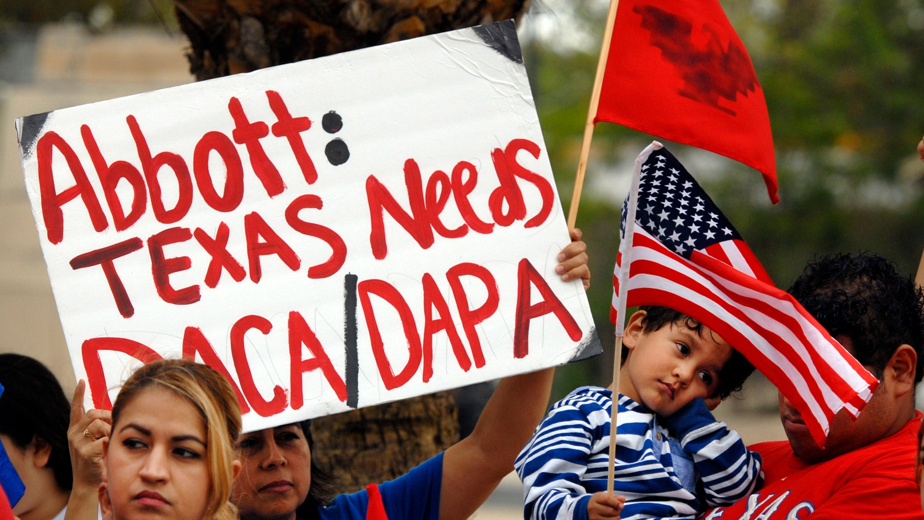 Over 100 hundred people demonstrated in front of the Federal Courthouse in Brownsville, Texas, Thursday, March 19, 2015. The Justice Department might face sanctions if a federal judge determines its attorneys misled him about whether part of President Barack Obama's executive action on immigration was implemented prior to it being put on hold by the judge. U.S. District Judge Andrew Hanen last month halted Obama's plan. The president's plan would spare from deportation up to 5 million people in the U.S. illegally. (AP Photo/Brownsville Herald, Brad Doherty)