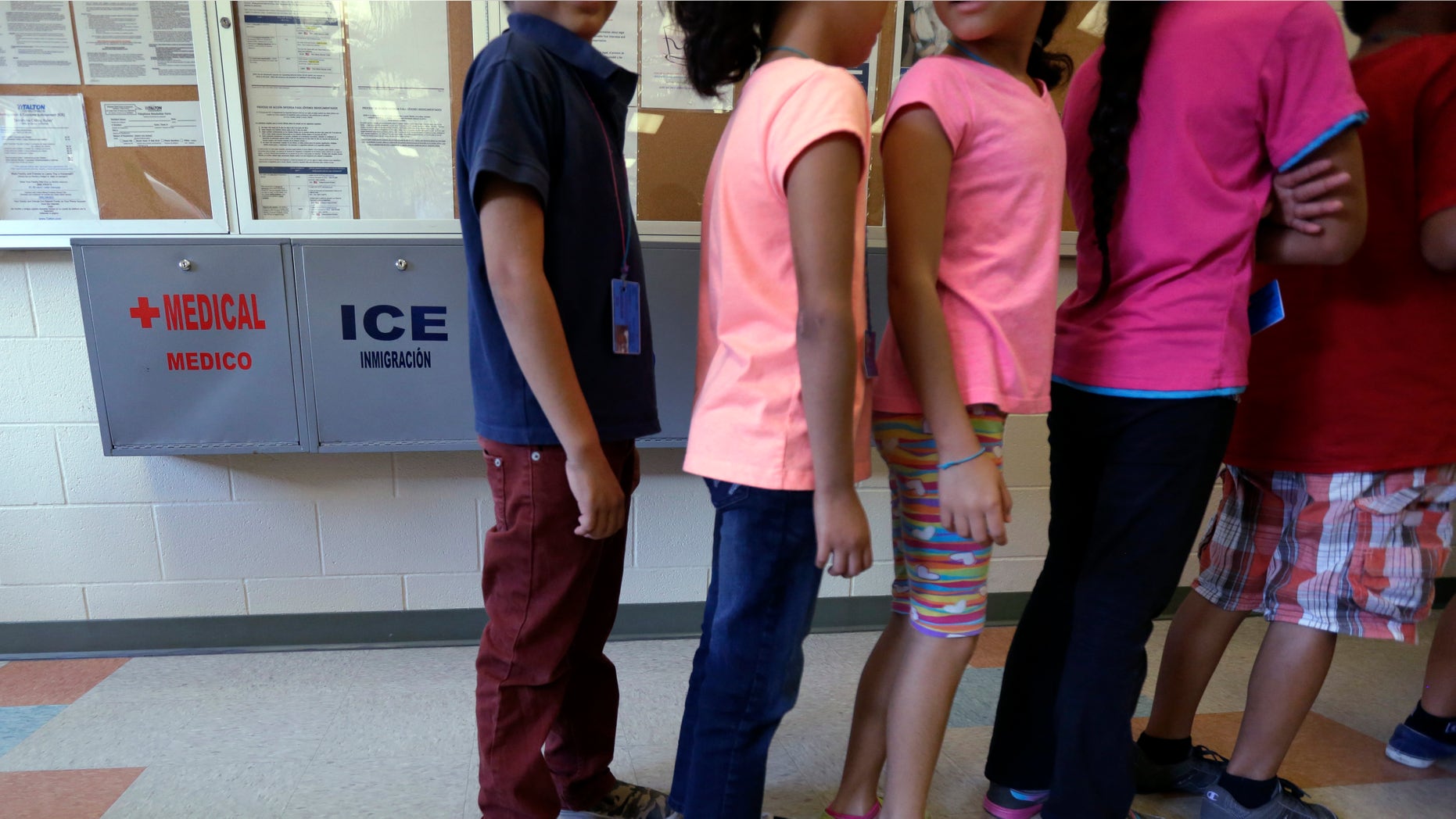 Detained immigrant children line up in a cafeteria at a temporary home in Karnes City, Texas.