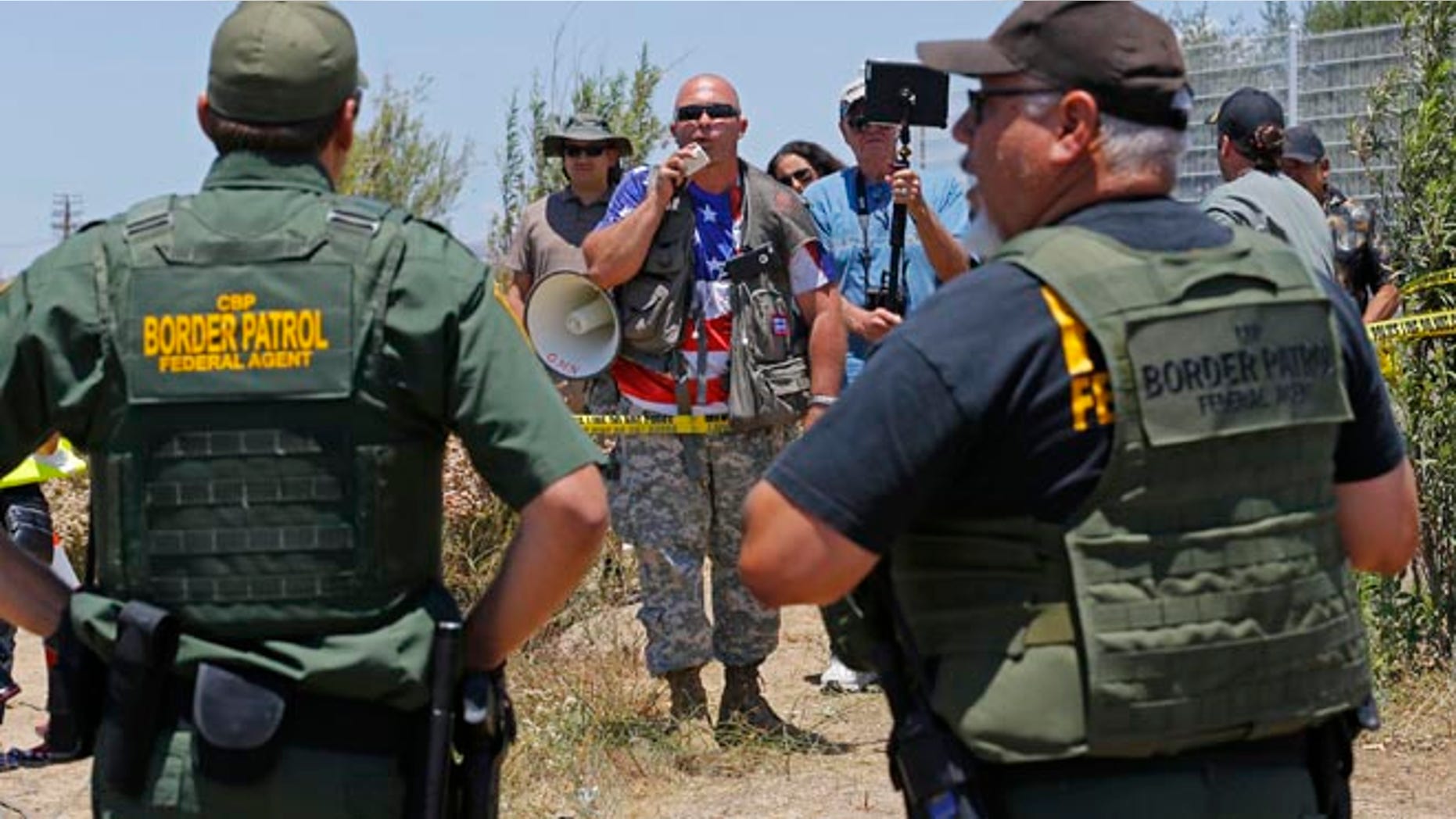 Border patrol officers during a immigration demonstration outside the Border Patrol facility Friday, July 4, 2014 in Murrieta, Calif.