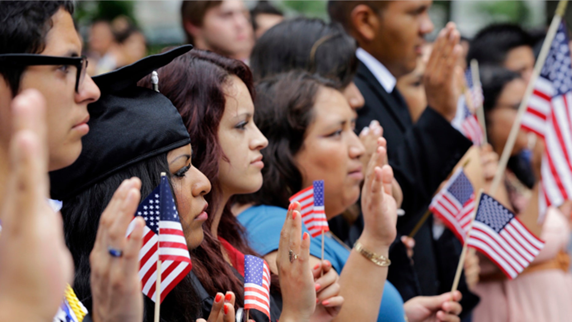 DREAMers (Development, Relief, and Education for Alien Minors) and parents take an oath in a mock citizenship ceremony during a "United we Dream," rally on Capitol Hill in Washington, Wednesday, July 10, 2013, sending a signal to the House of Representativesâ GOP leadership as they go into their meeting that afternoon to discuss immigration reform with their caucus. (AP Photo/Alex Brandon)
