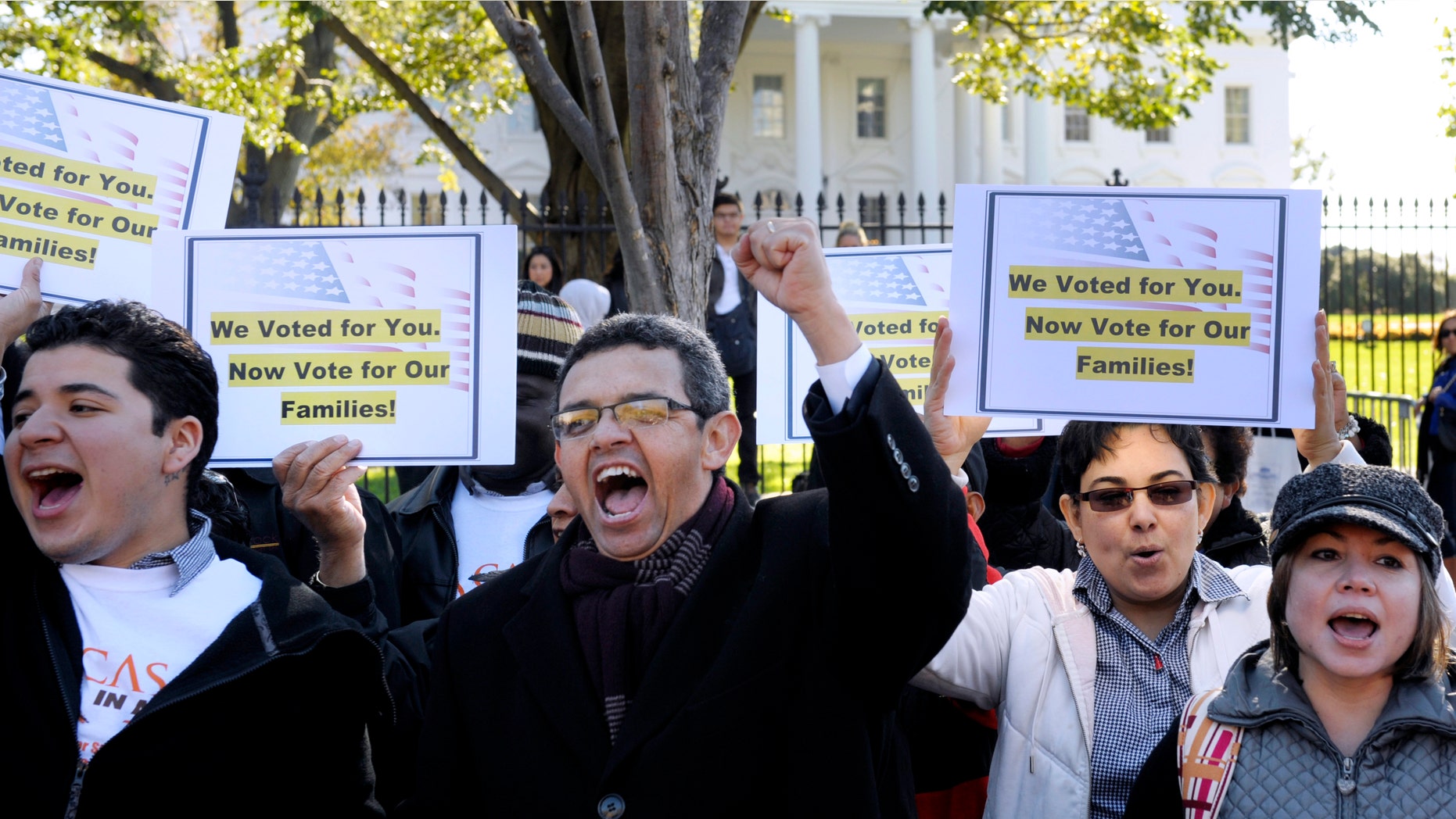 Gustavo Torres, director, Casa in Action, center, and others, chant during a rally of immigration rights organizations, including Casa in Action and Maryland Dream Act, in front of the White House in Washington, Thursday, Nov. 8, 2012, calling on President Barack Obama to fulfill his promise of passing comprehensive immigration reform. (AP Photo/Cliff Owen)