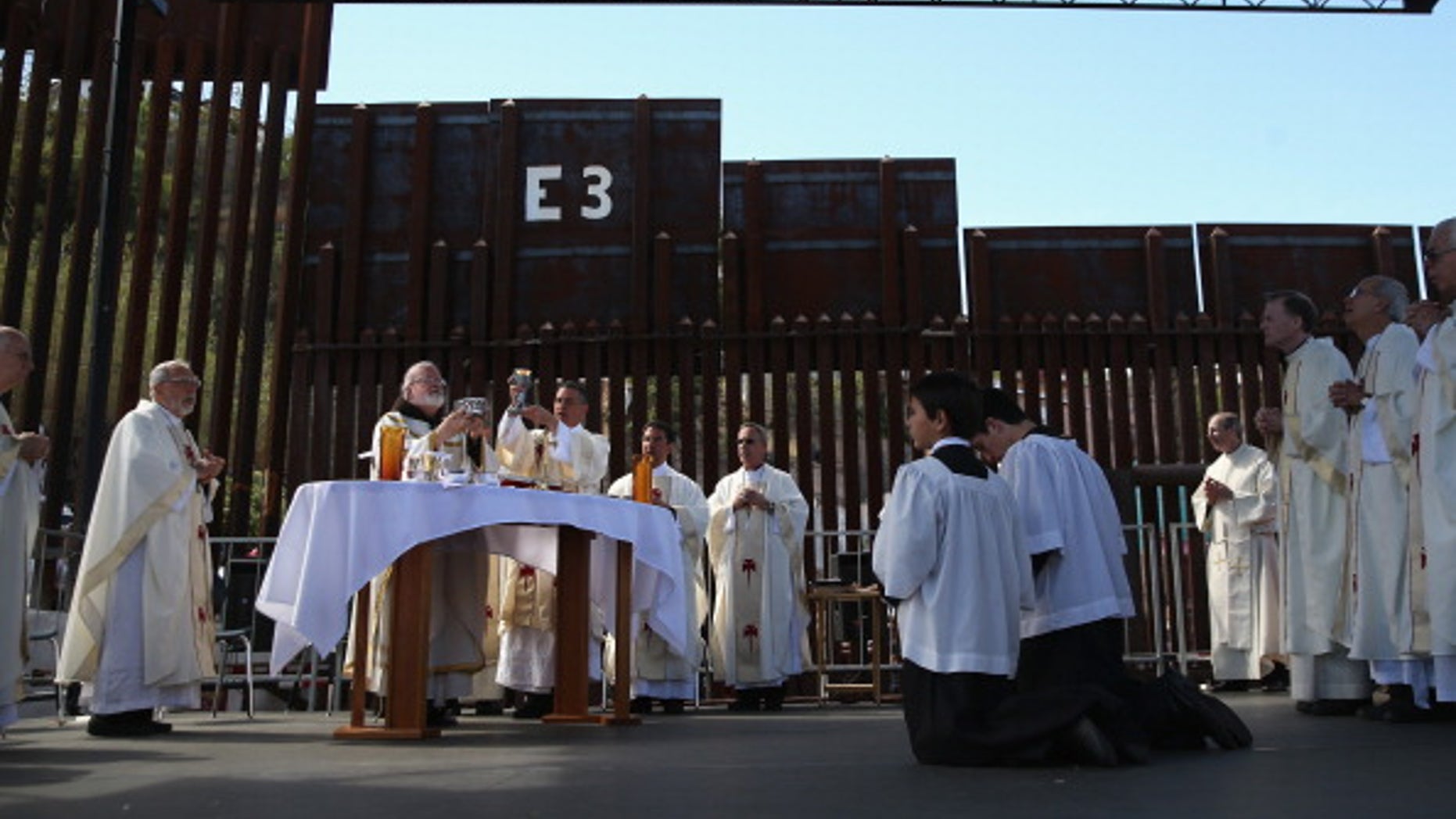 NOGALES, AZ - APRIL 01: Archbishop of Boston Cardinal Sean O'Malley (L), and fellow Catholic clergy stand next to the U.S.-Mexico border fence during a special 'Mass on the Border' on April 1, 2014 in Nogales, Arizona. Catholic bishops led by Cardinal O'Malley held the mass at the border fence to pray for comprehensive immigration reform and for those who have died along the border. (Photo by John Moore/Getty Images)