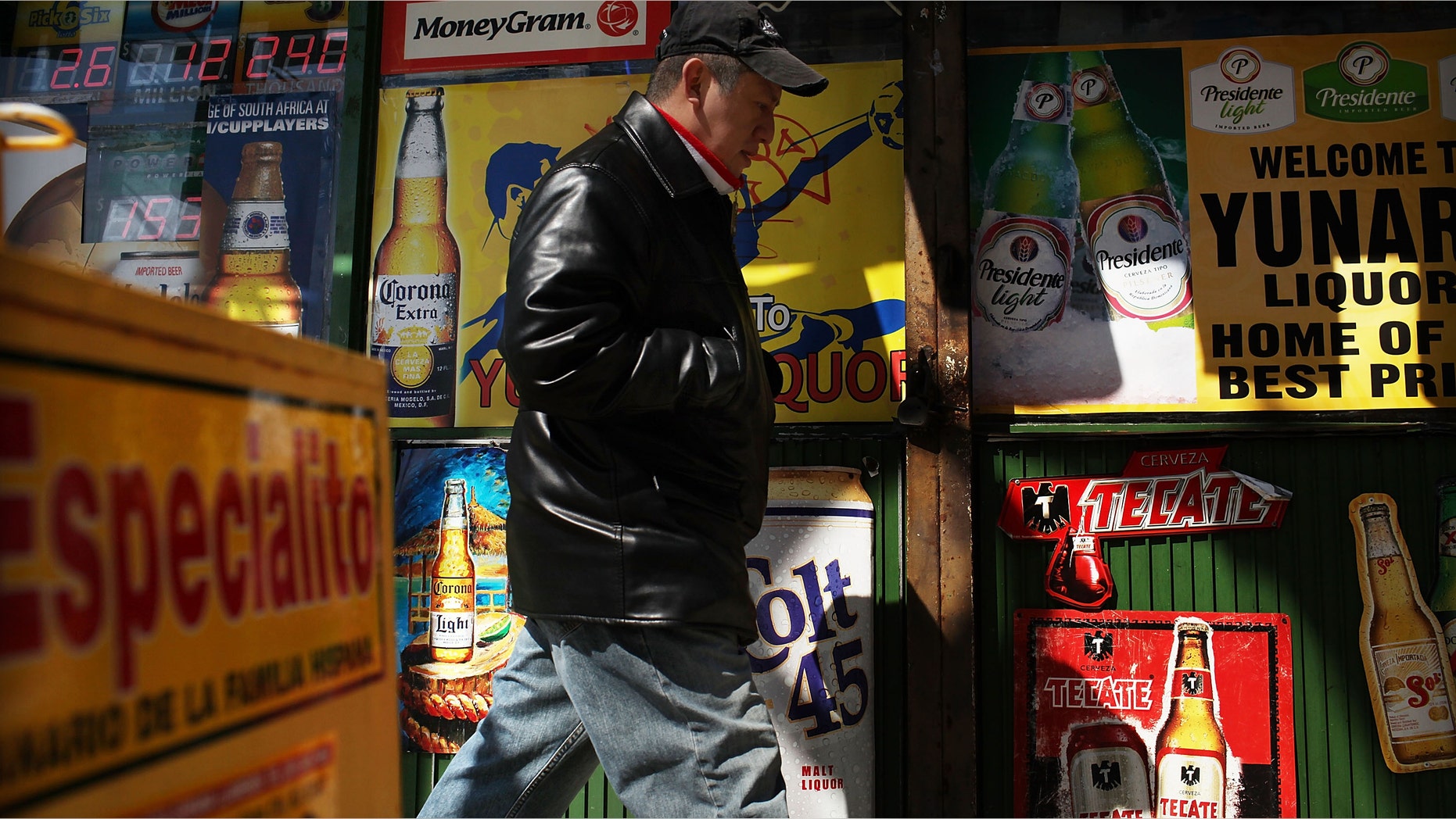 UNION CITY, NJ - MARCH 28: A man walks by adds in Spanish outside of a bodega on March 28, 2011 in Union City, New Jersey. Union City New Jersey, one of the stateâs largest cities, has a population of Hispanic or Latino origin of over 80%. According to the new 2010 Census Bureau statistics reported last Thursday, the Hispanic population in the United States has grown by 43% in the last decade, surpassing 50 million and accounting for about 1 out of 6 Americans. (Photo by Spencer Platt/Getty Images)