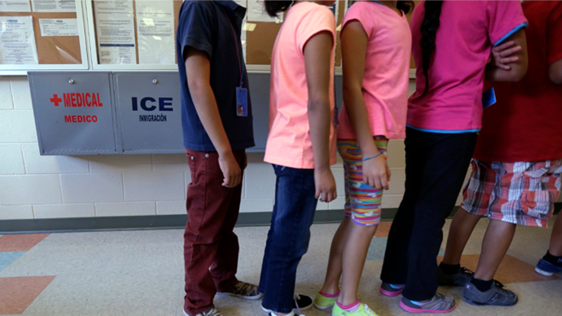 FILE - In this Sept. 10, 2014 file photo, detained immigrant children line up in the cafeteria at the Karnes County Residential Center in Karnes City, Texas. Karnes, one of the nation's largest detention centers for families caught crossing the southern U.S. border received a temporary residential child-care license from the Texas Department of Family and Protective Services. DFPS spokesman Patrick Crimmins said Tuesday May 3, 2016, the agency granted the six-month license last week to the facility. (AP Photo/Eric Gay, File)