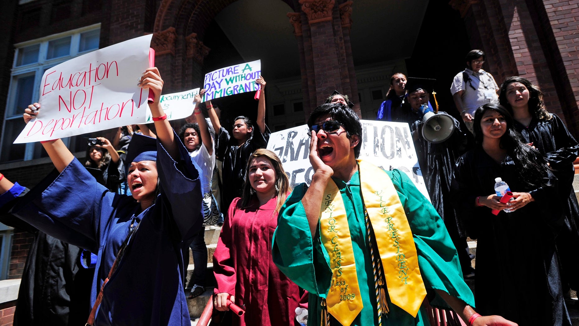 August 23: Gustavo Madrigal, right, shouts outside the admissions office during a protest at the University of Georgia in Athens, Ga. The group gathered to protest a new university system policy on the admission of illegal immigrants, the latest in a string of demonstrations staged in recent months in Georgia by illegal immigrant young people and their supporters.
