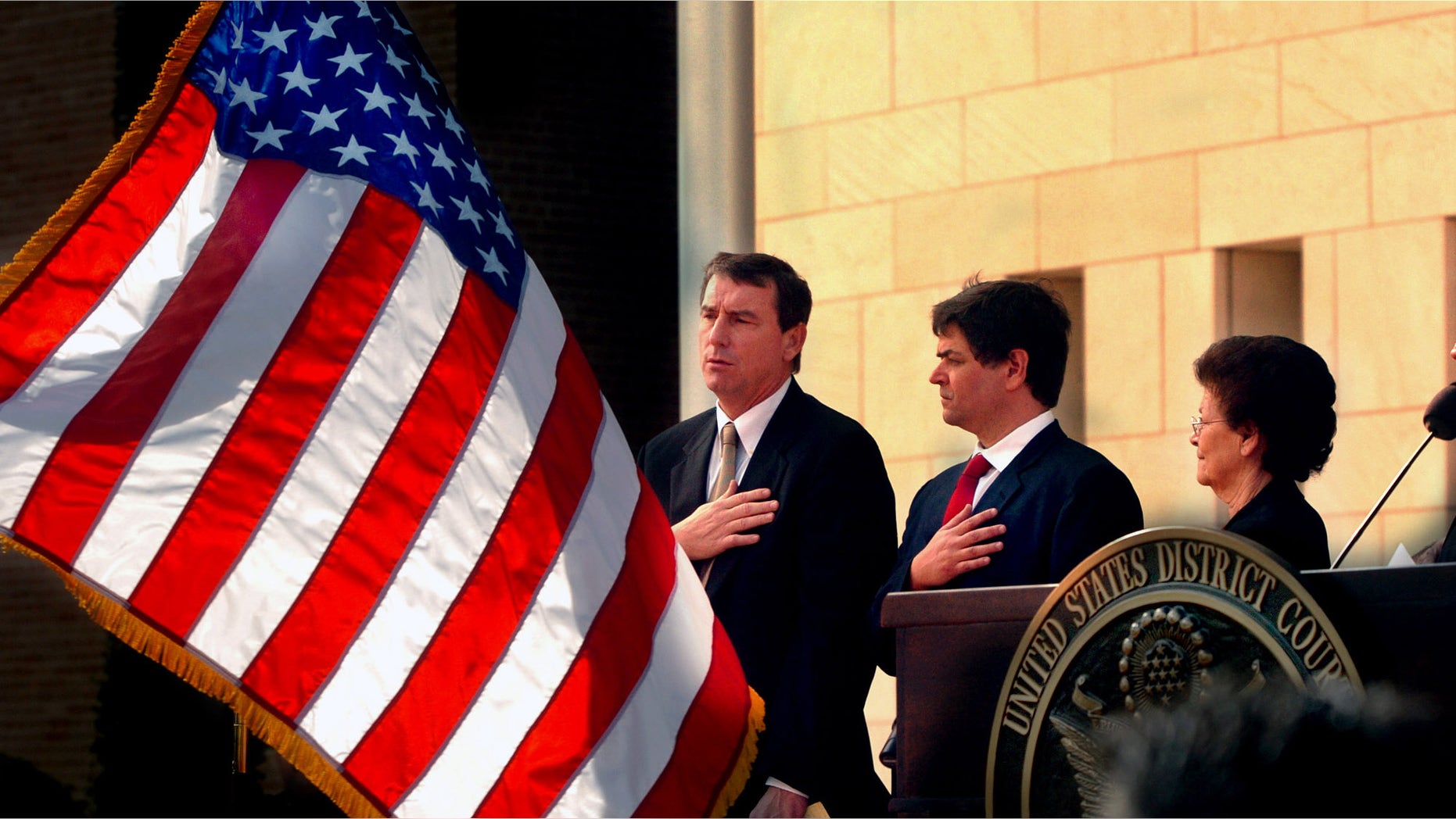 FILE - In this Nov. 14, 2005 file photo, U.S. Southern District Judge Andrew S. Hanen, left, joins with Filemon B. Vela, Jr. and Blanca Vela for the Pledge of Allegiance during the United States Courthouse naming ceremony in Brownsville, Texas. Hanen's move to block President Barack Obamaâs orders on immigration lays bare a pervasive but not widely known practice in federal district courts: venue shopping. Immigration advocates say that lawyers for the state of Texas were seeking a court with sympathetic judges when they filed their case in Brownsville. (AP Photo/The Brownsville Herald, Brad Doherty, File)