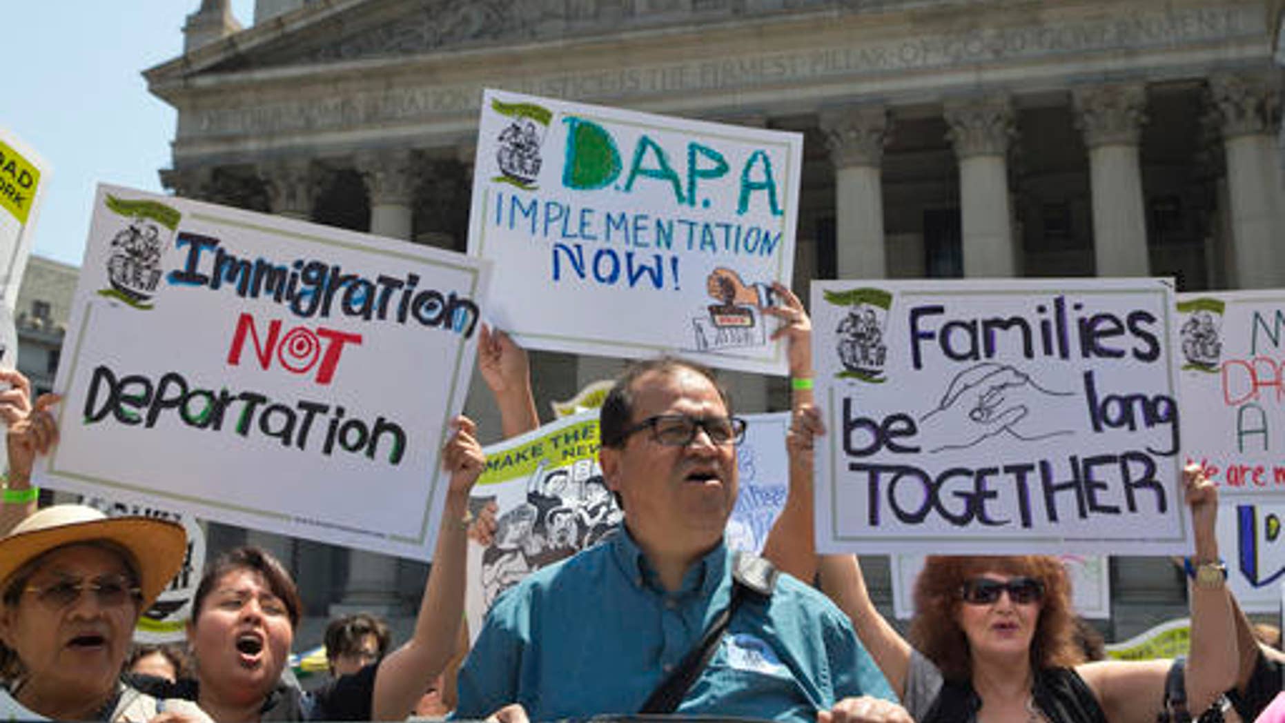 FILE - In this June 24, 2016, file photo, demonstrators protest against a Supreme Court decision on immigration outside the New York Supreme court in New York. The future of millions of people living in the U.S. illegally could well be shaped by the presidential election. The stakes are high, too, for those who employ them, help them fit into neighborhoods, or want them gone. (AP Photo/Mary Altaffer, File)