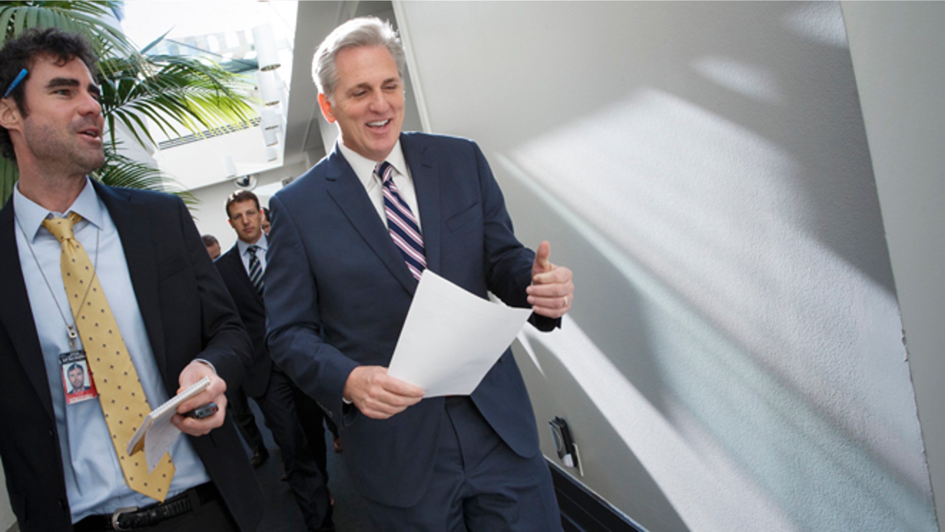 House Majority Leader Kevin McCarthy of Calif., center, walks with a reporters as on Capitol Hill in Washington, Friday, Jan. 9, 2015, as House Republicans leave a closed-door meeting on thwarting President Barack Obama's executive actions on immigration by blocking the funding for the Department of Homeland Security, Obama's directives in November gave temporary relief from deportation to about 4 million immigrants in the country illegally, along with permits allowing them to work legally in the U.S. His move infuriated Republicans after their midterm election victories, and they vowed to retaliate once they assumed full control of Congress this week. (AP Photo/J. Scott Applewhite)