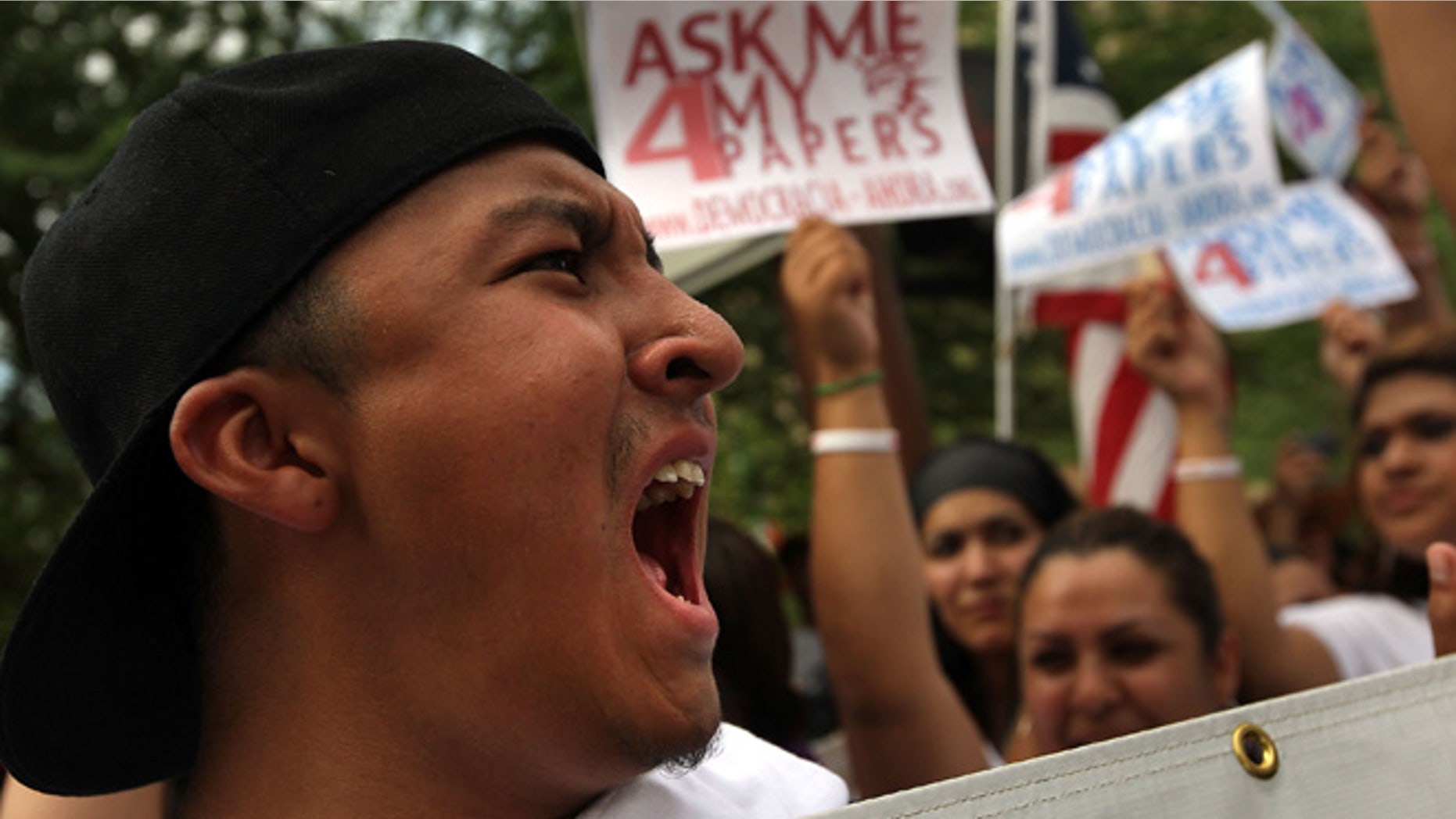 PHOENIX - JULY 29: A protester shouts at riot police at a demonstration against Arizona's immigration enforcement law SB 1070 on July 29, 2010 in Phoenix, Arizona. Protesters blocked a main downtown street in a show of civil disobedience to show opposition to the new law and riot police responded with arrests. U.S. District Court Judge Susan Bolton issued a preliminary injunction yesterday preventing several sections of Arizona's new immigration law from going into effect, at least until the courts have a chance to hear the full case. (Photo by John Moore/Getty Images)