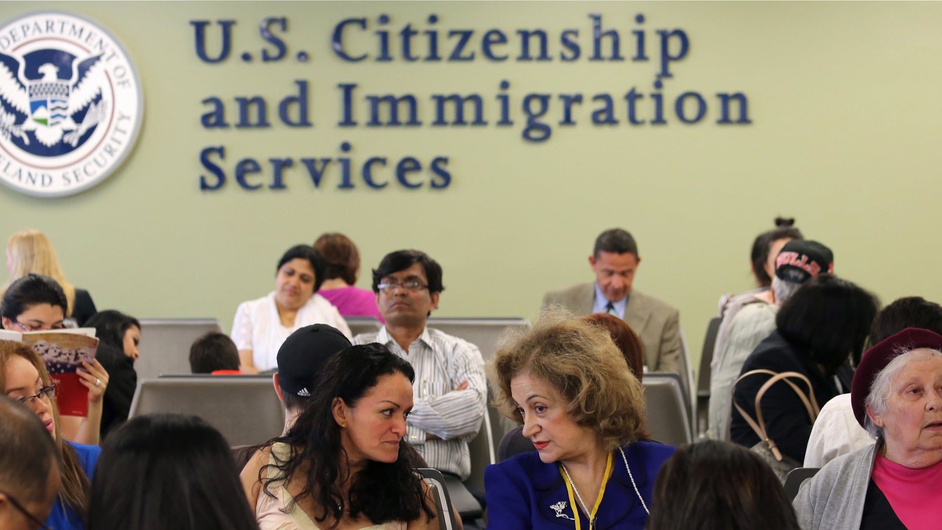 NEW YORK, NY - MAY 30: Immigrants await their turn for green card and citizenship interviews at the U.S. Citizenship and Immigration Services (USCIS) Queens office on May 30, 2013 in the Long Island City neighborhood of the Queens borough of New York City. The branch office is located in an area heavily populated by immigrants and processes thousands of Green Card and U.S. citizenship applications each year. (Photo by John Moore/Getty Images)