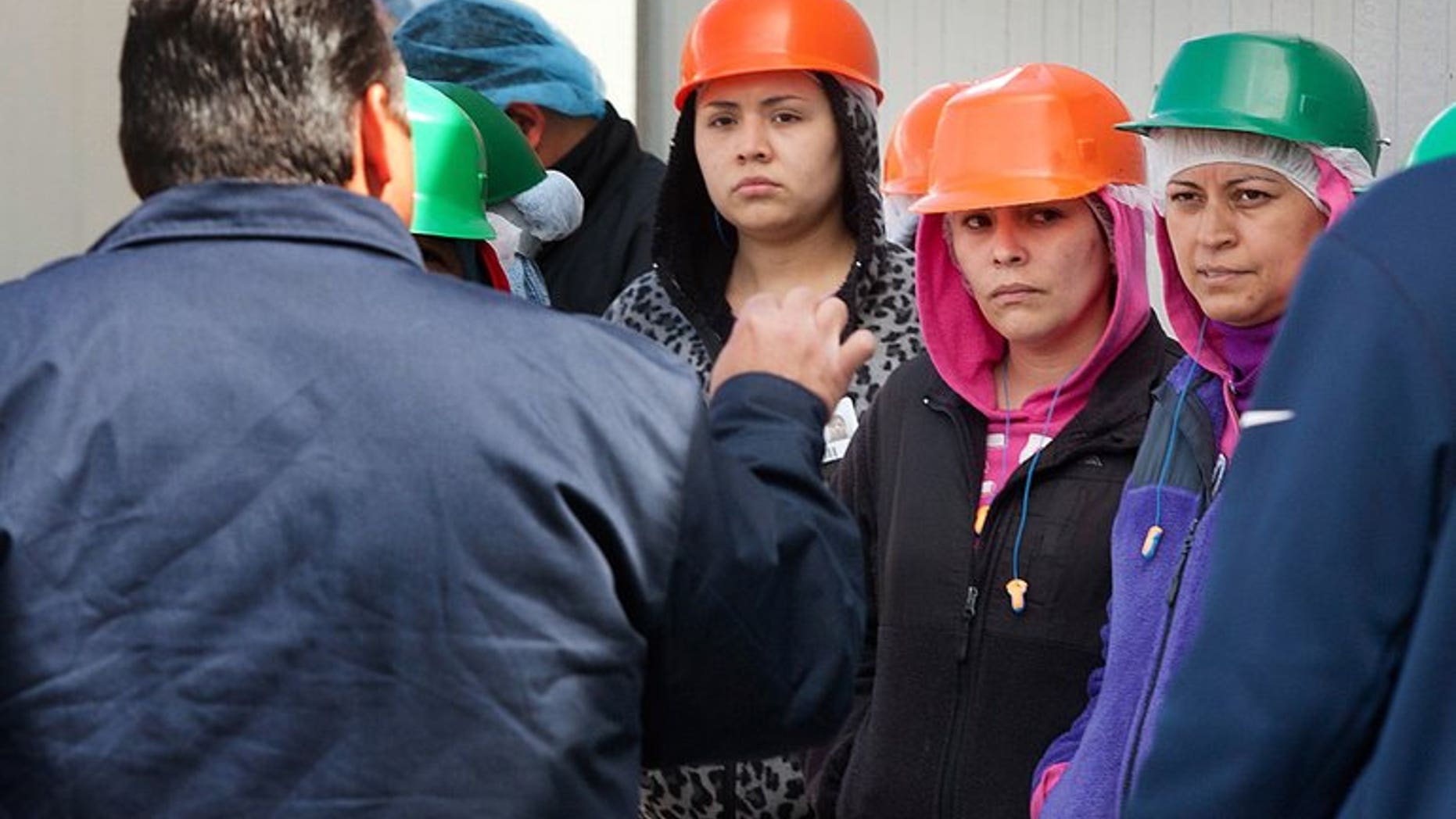 Manager Hector Calderon speaks to workers protesting Friday outside the Cashmere production warehouse.