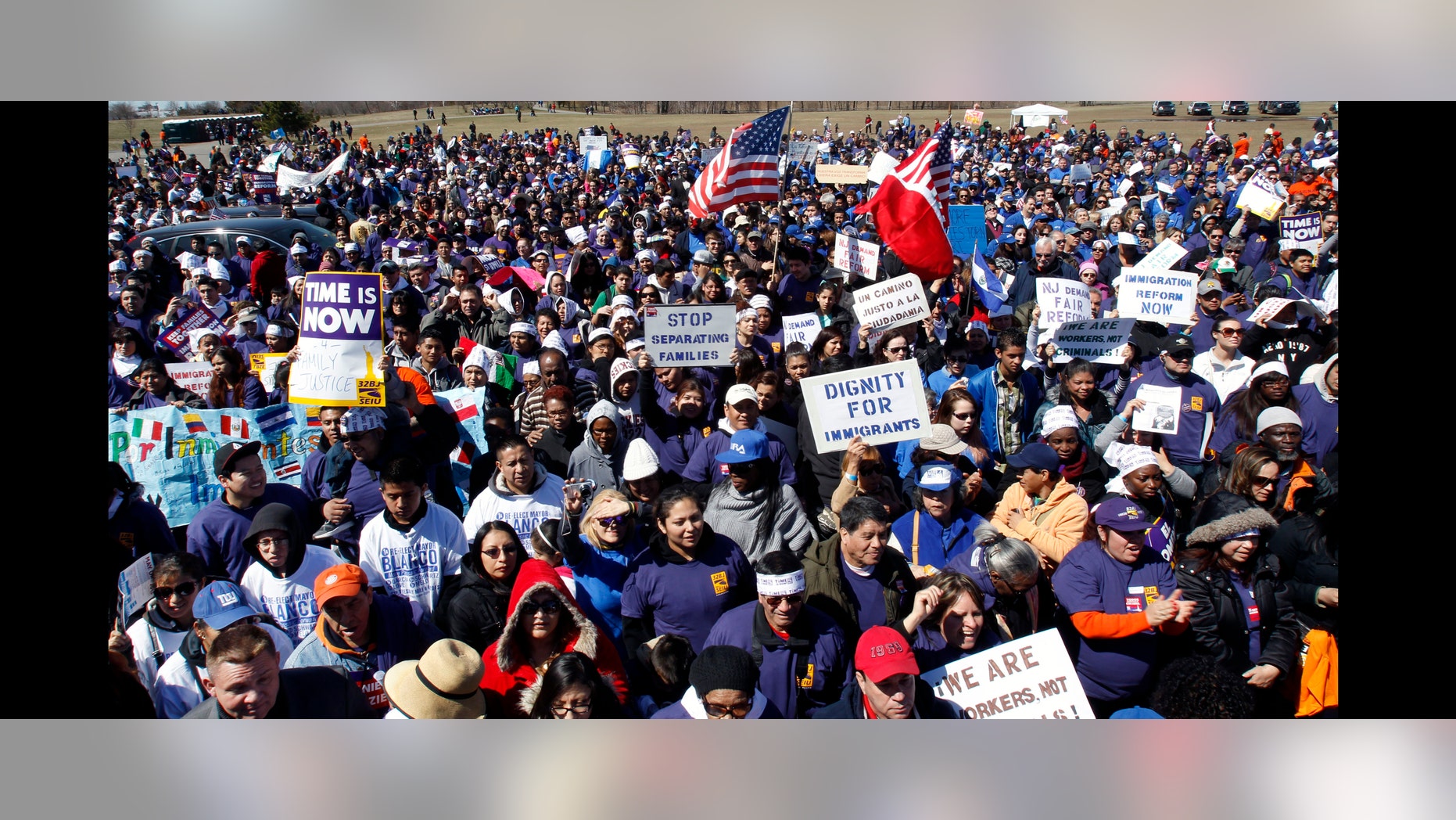 People gather as members of New Jersey's congressional delegation as well as labor unions, religious leaders, immigrants and immigration advocates rally in Liberty State Park on Saturday, April 6, 2013, in Jersey City, N.J. One of several demonstrations being held across the nation under the 'Time is Now' banner, the events are being held to urge Congress to pass immigration reform. They want to express their support for proposed changes in federal immigration laws that would put an estimated 11 million immigrants living in the country illegally on a path to citizenship. (AP Photo/Mel Evans)