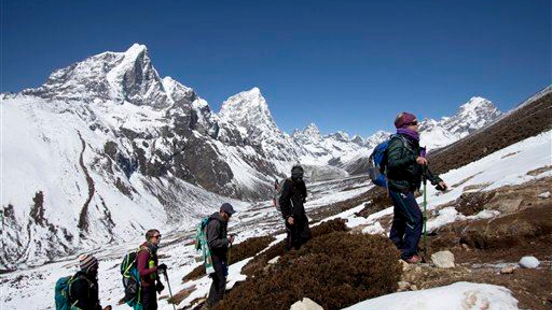 In this March 18, 2015, file photo, trekkers take an acclimatization hike on the way to Everest base camp in Nepal.