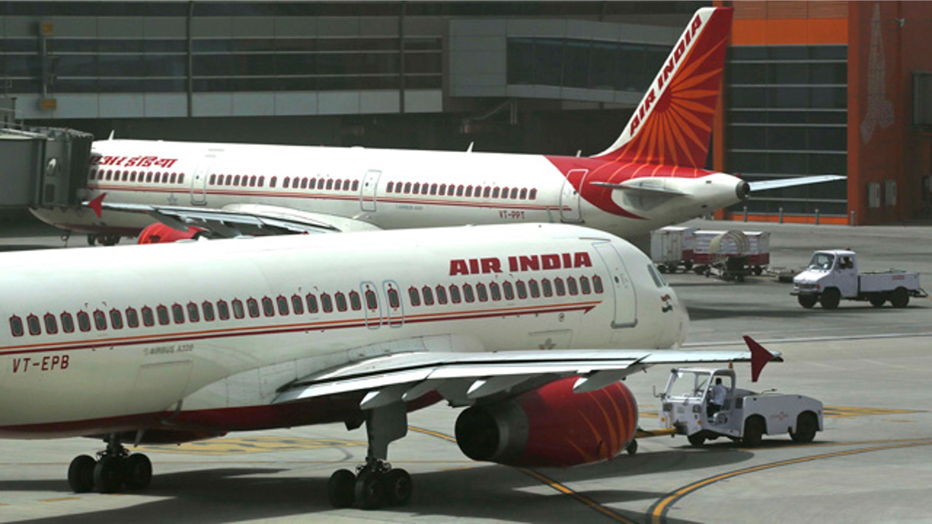 FILE - In this May 18, 2012, file photo, Air India planes are parked on the tarmac at the Terminal 3 of Indira Gandhi International Airport in New Delhi, India. (AP Photo/Kevin Frayer, File)