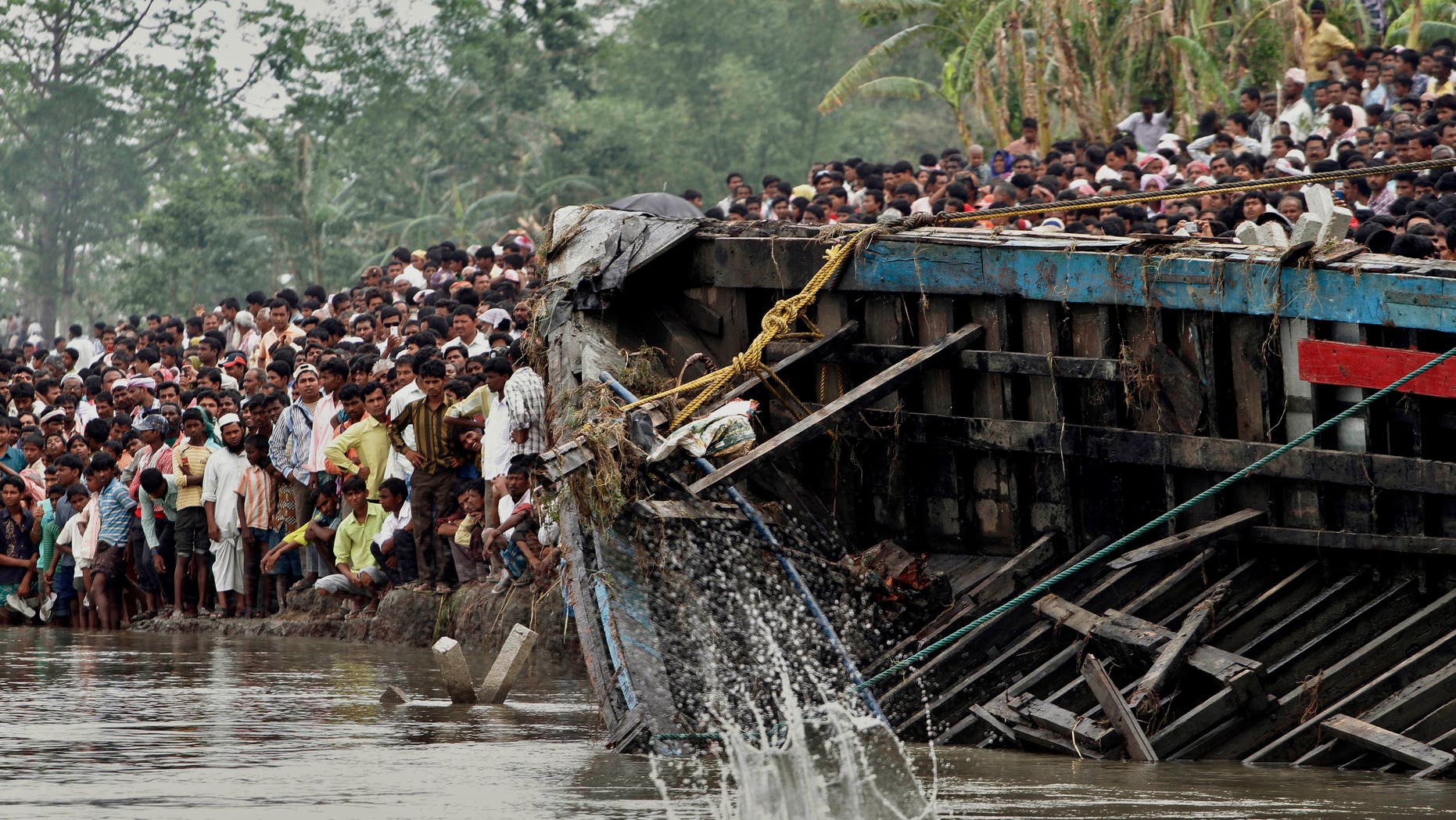 May 1, 2012: Rescuers pull out the wreckage of a ferry that capsized in the Brahmaputra River at Buraburi village, about 215 miles west of the state capital Gauhati, India.