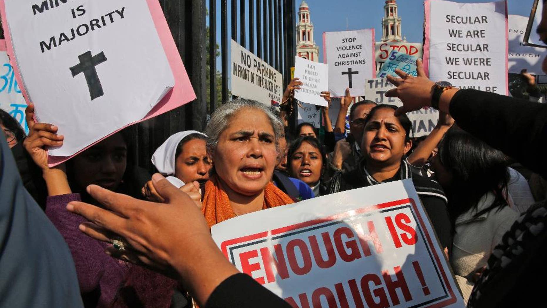 Indian Christians hold placards protesting against attacks on churches in the Indian capital as they assemble outside the Sacred Heart Church in New Delhi, India.