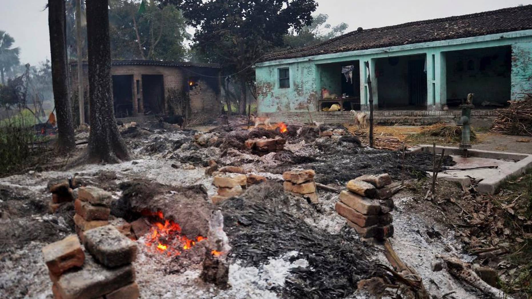 In this Sunday, Jan. 18, 2015 photo, the remains of burnt and ransacked huts still smolder in a village following a clash between two communities in a village, nearly 105 kilometers (65 miles) north of Patna, the Indian capital of Bihar state. At least four Muslims were burned to death Sunday when their thatched huts were set on fire during a clash between Hindu and Muslim groups in a village in eastern India, a government official said. (AP Photo/ Press Trust Of India) INDIA OUT