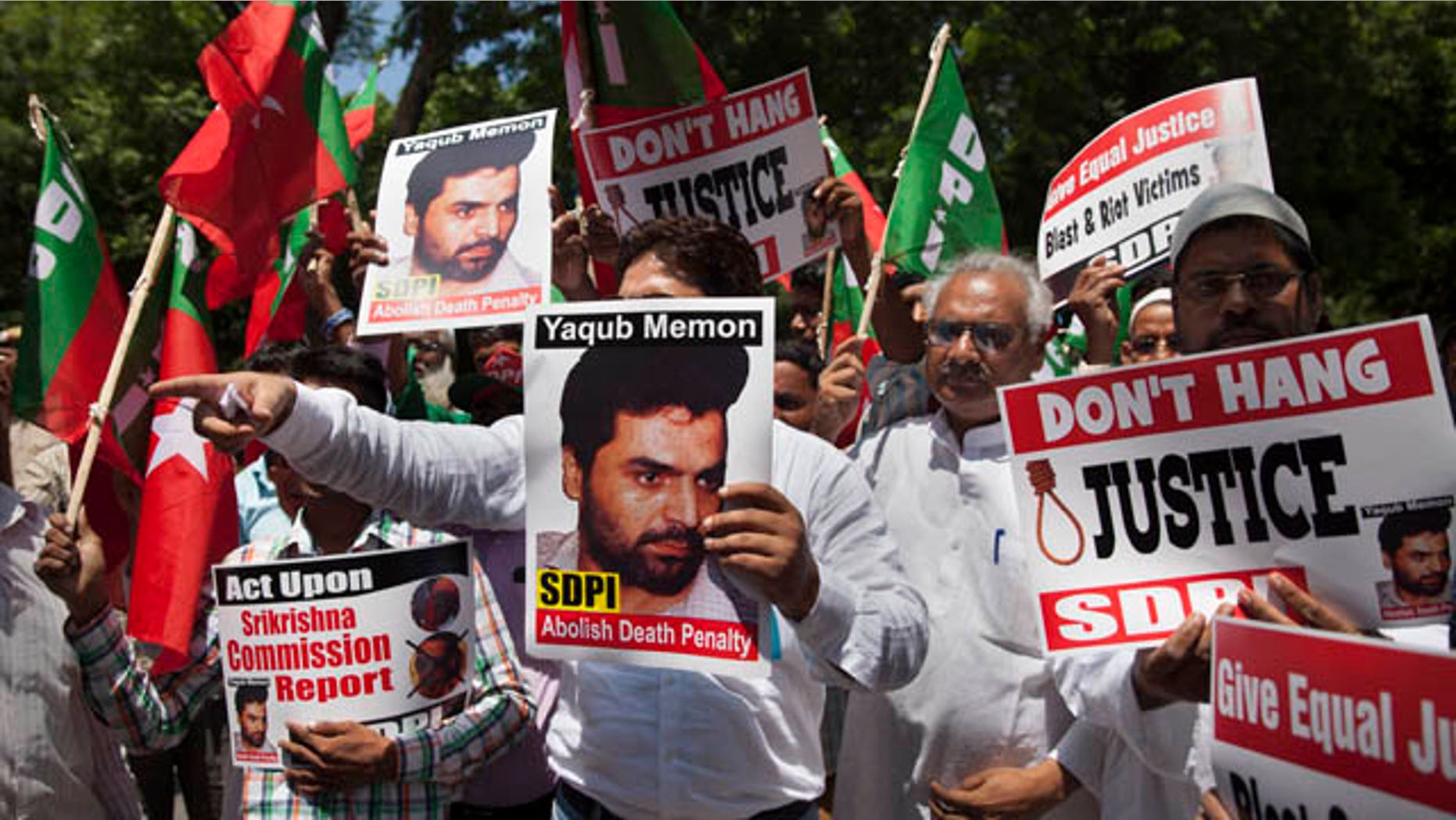 July 27, 2015: Activists of the Social Democratic Party of India carry placards with portraits of Yakub Abdul Razak Memon, convicted in the 1993 Mumbai bombings, during a protest against his death sentence outside Maharashtra House in New Delhi. (AP Photo/Tsering Topgyal)