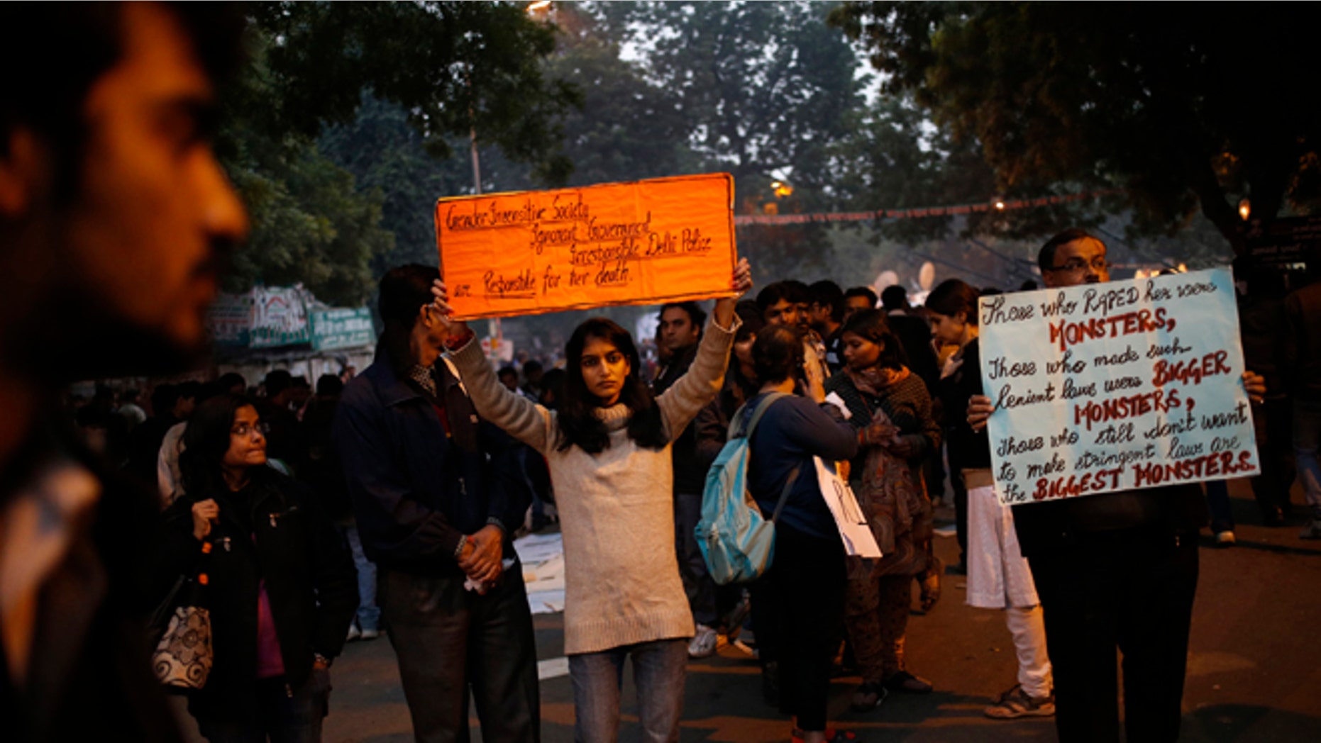 Dec. 29, 2012: Indian women and men hold placards as they mourn the death of a gang rape victim in New Delhi, India.