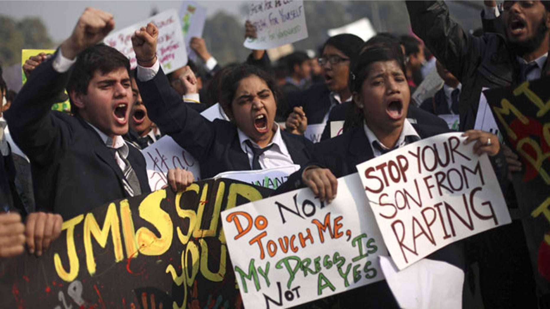 In this Dec. 22, 2012 file photo, Indian schoolchildren hold placards and shout slogans during a protest against the Dec. 16 gang rape and beating of a young woman on a city bus in New Delhi, India. (AP Photo)