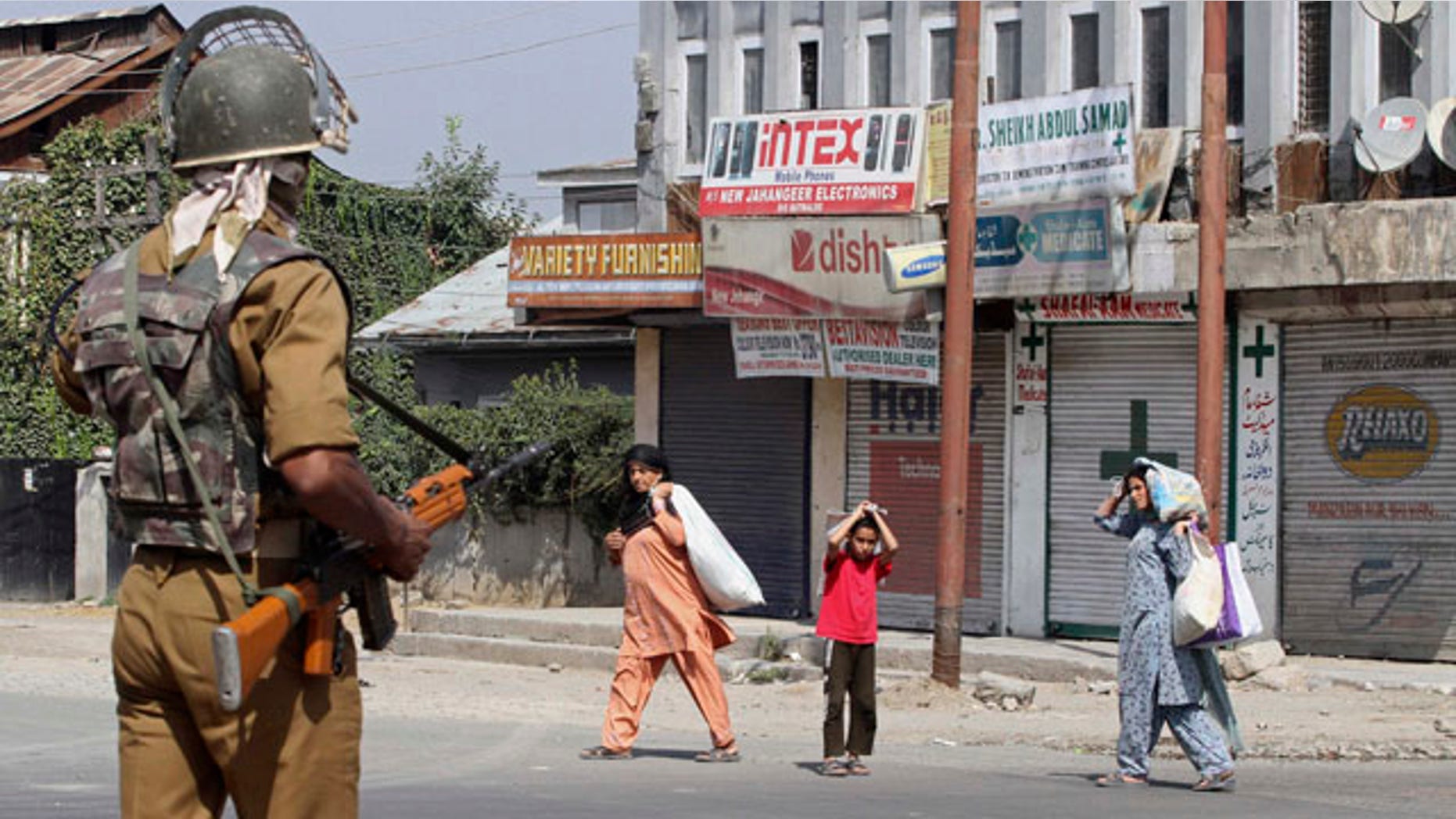 September 17: An Indian paramilitary soldier asks civilians to stay indoors during curfew in Srinagar, India. Violent civil unrest against New Delhi's rule in Kashmir has roiled the disputed Himalayan region for the past three months and killed dozens, prompting authorities to declare curfew. (AP)