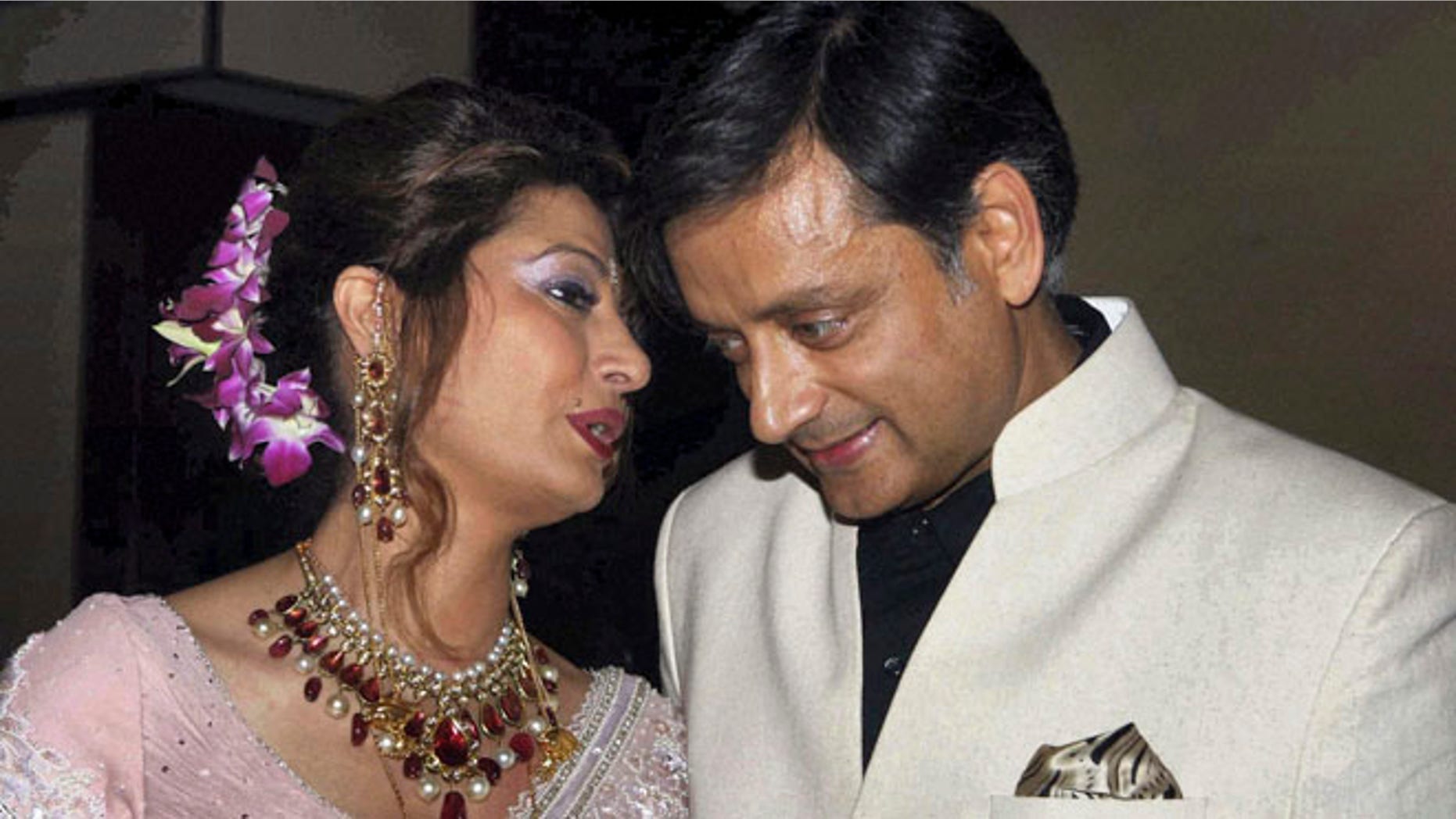 Sept. 4, 2010: In this file photo, former Indian Junior Foreign Minister Shashi Tharoor listens to his wife Sunanda Pushkar at their wedding reception in New Delhi, India.
