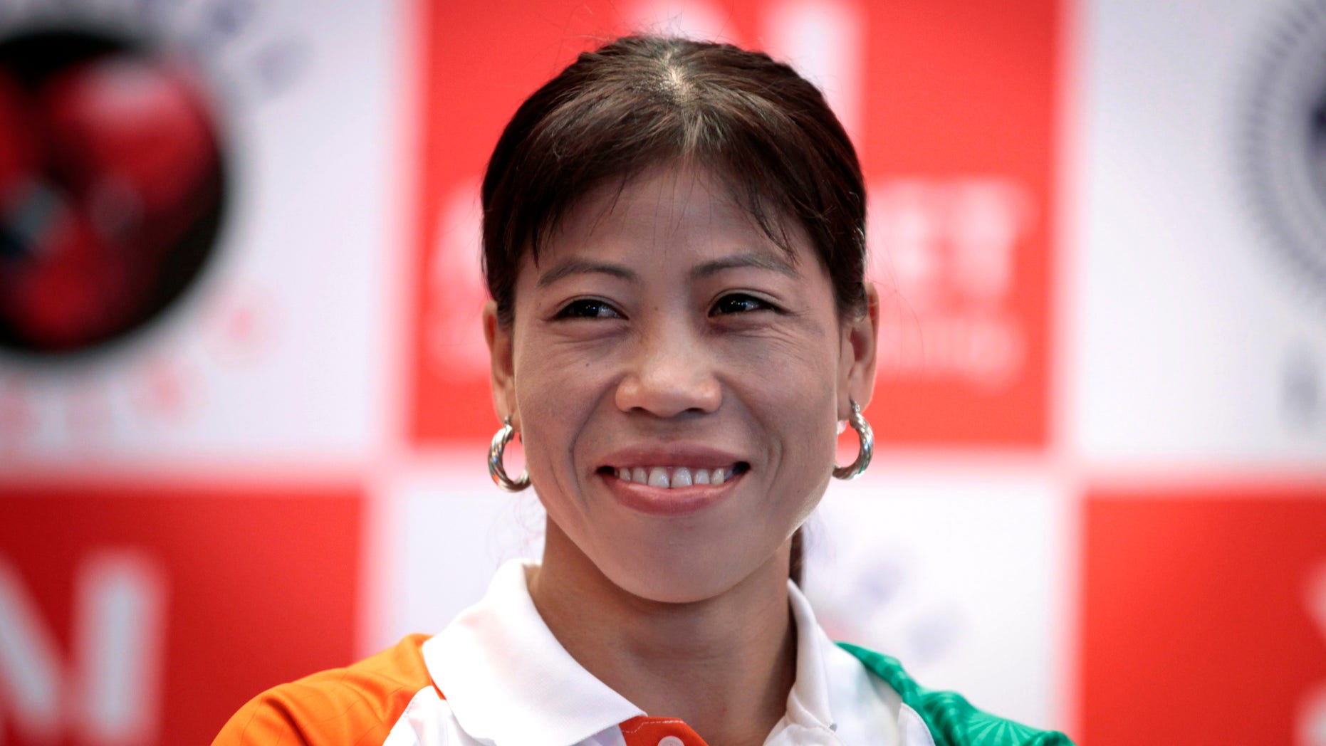 July 12, 2012: Indian woman boxer M.C. Mary Kom, who will compete in the upcoming Olympic Games, smiles during a press conference in New Delhi, India.