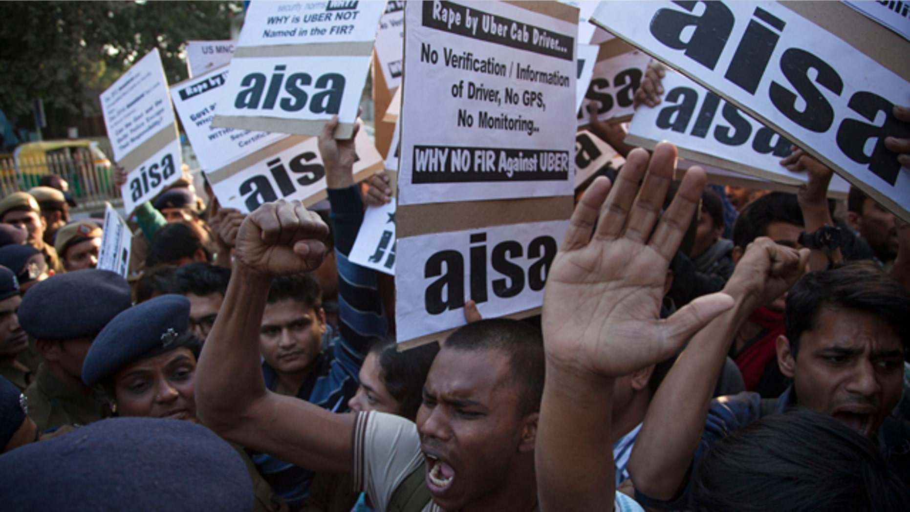 December 7, 2014: Protestors from All India Students Association (AISA) demonstrate outside the Delhi Police headquarters after a taxi driver from the international cab-booking service Uber allegedly raped a young woman Friday in New Delhi. (AP Photo/Tsering Topgyal)
